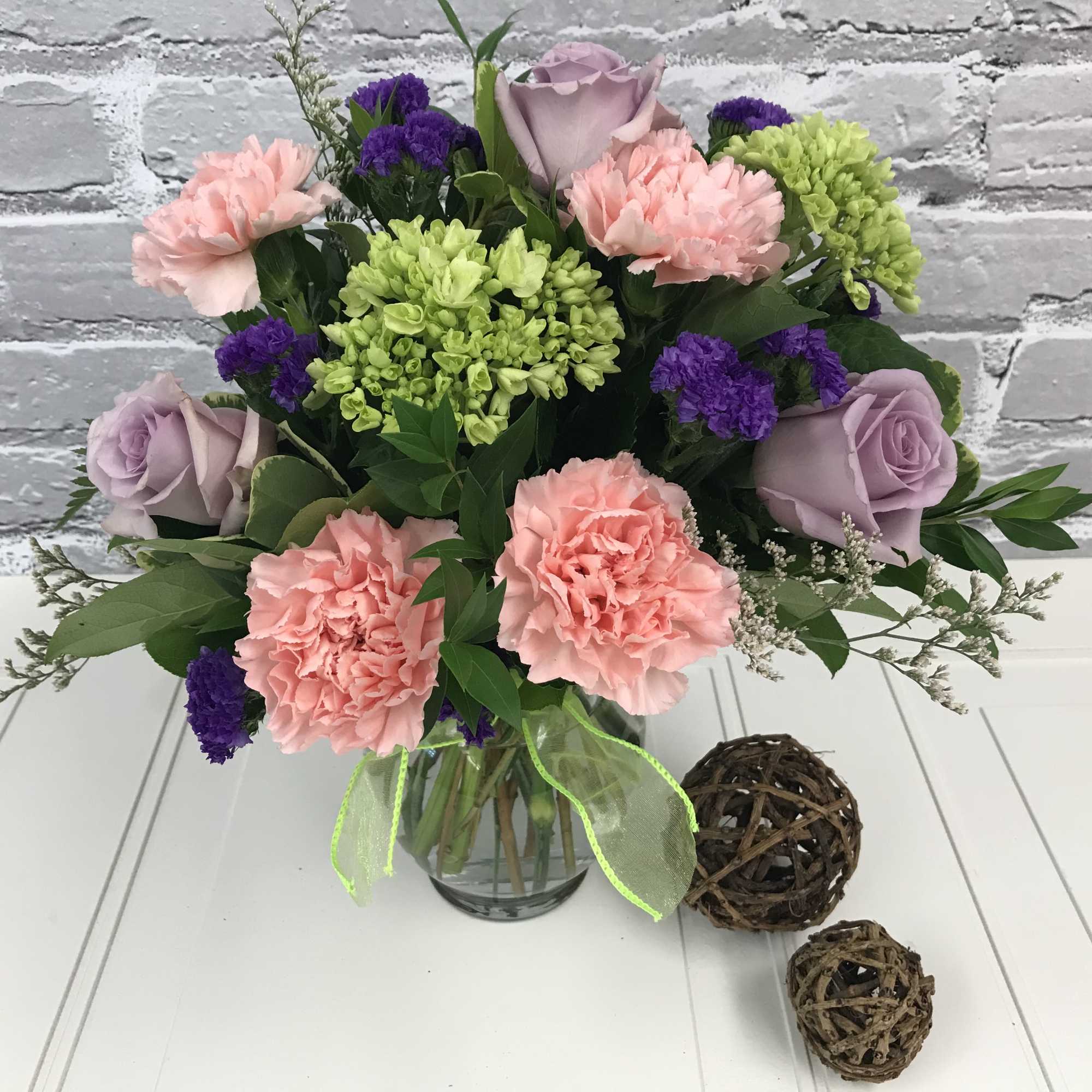 Stunning lavender roses are combined with lush mini green hydrangeas and pink