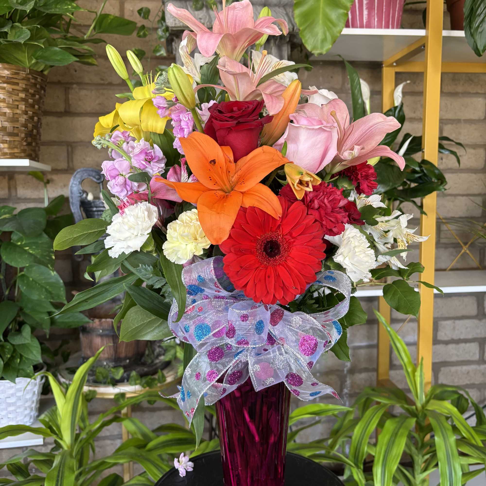 fresh mix of flowers in long tall vase 

The color of Gerber