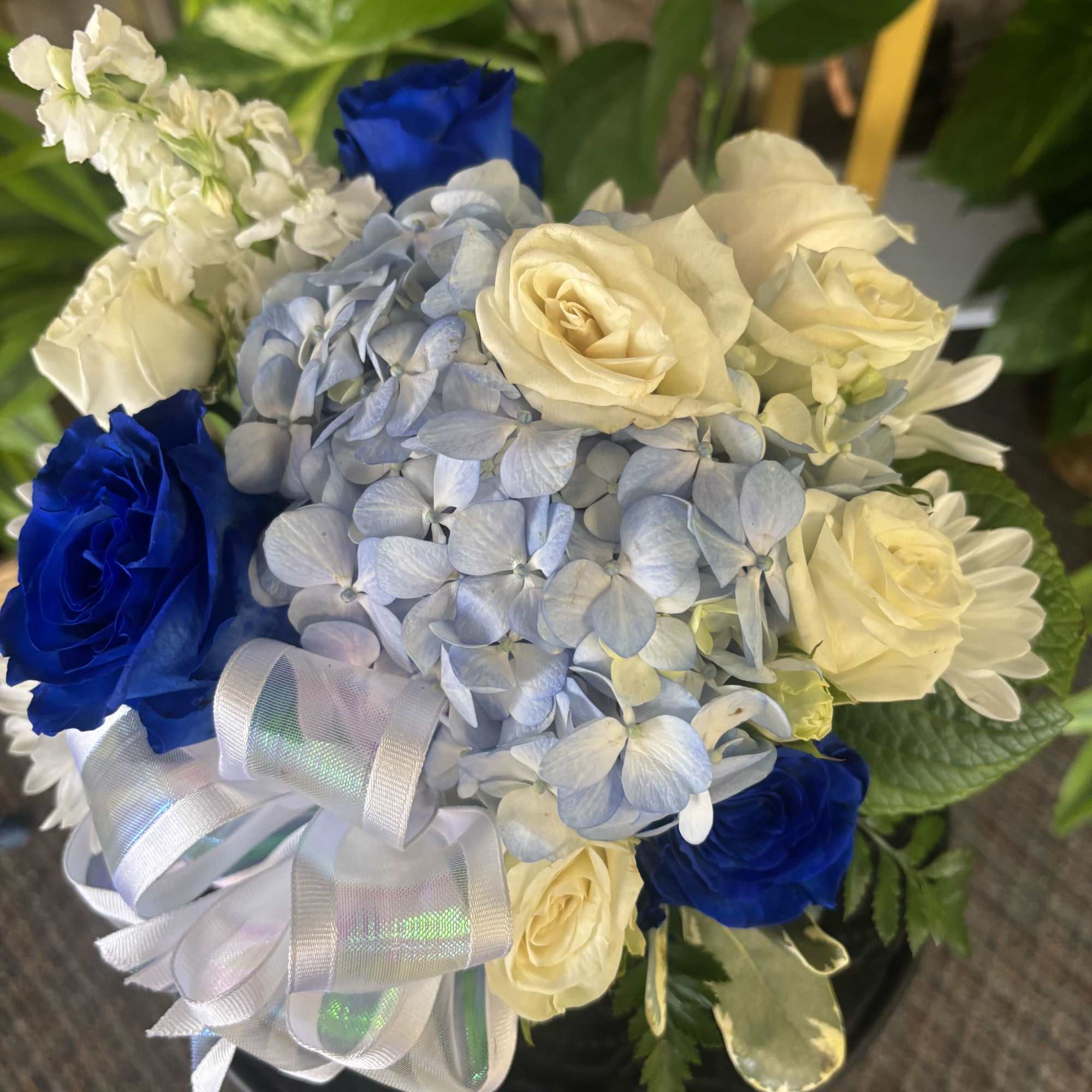 Fresh flowers in blue cube 