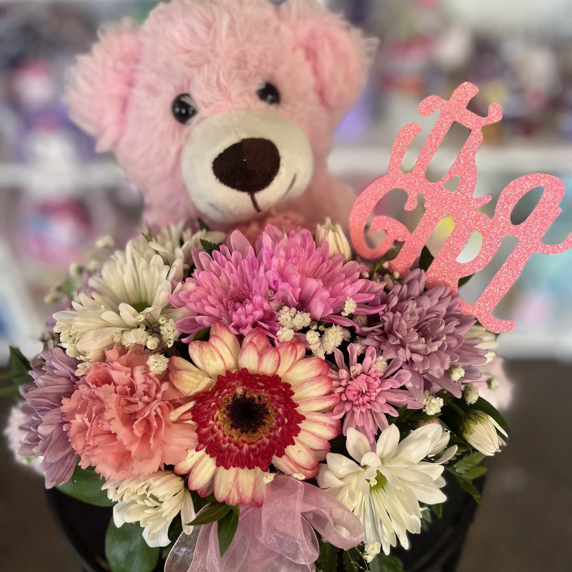 fresh flowers in basket with pink bear 

The color of Gerber flowers