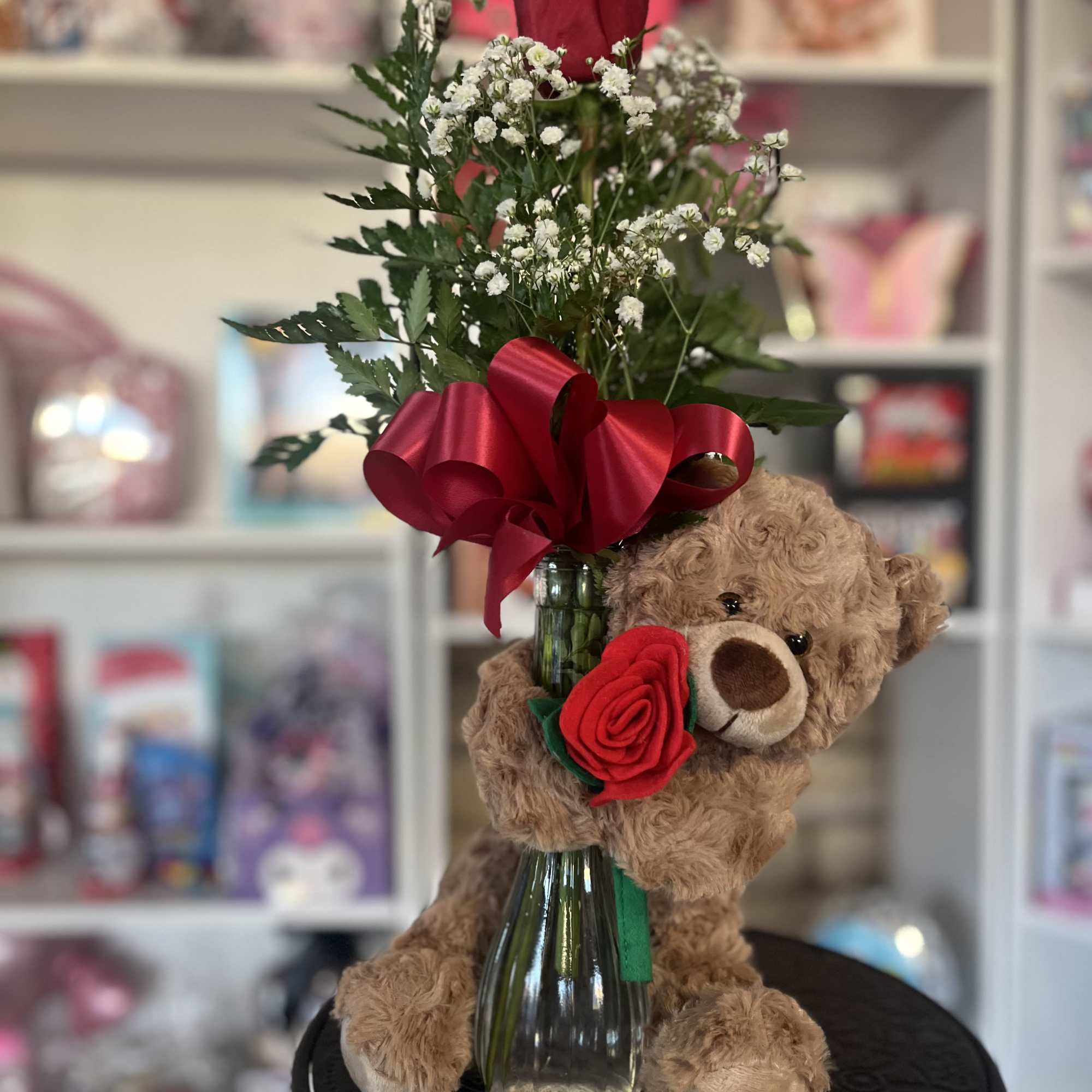 fresh rose in bud vase with floral bear 