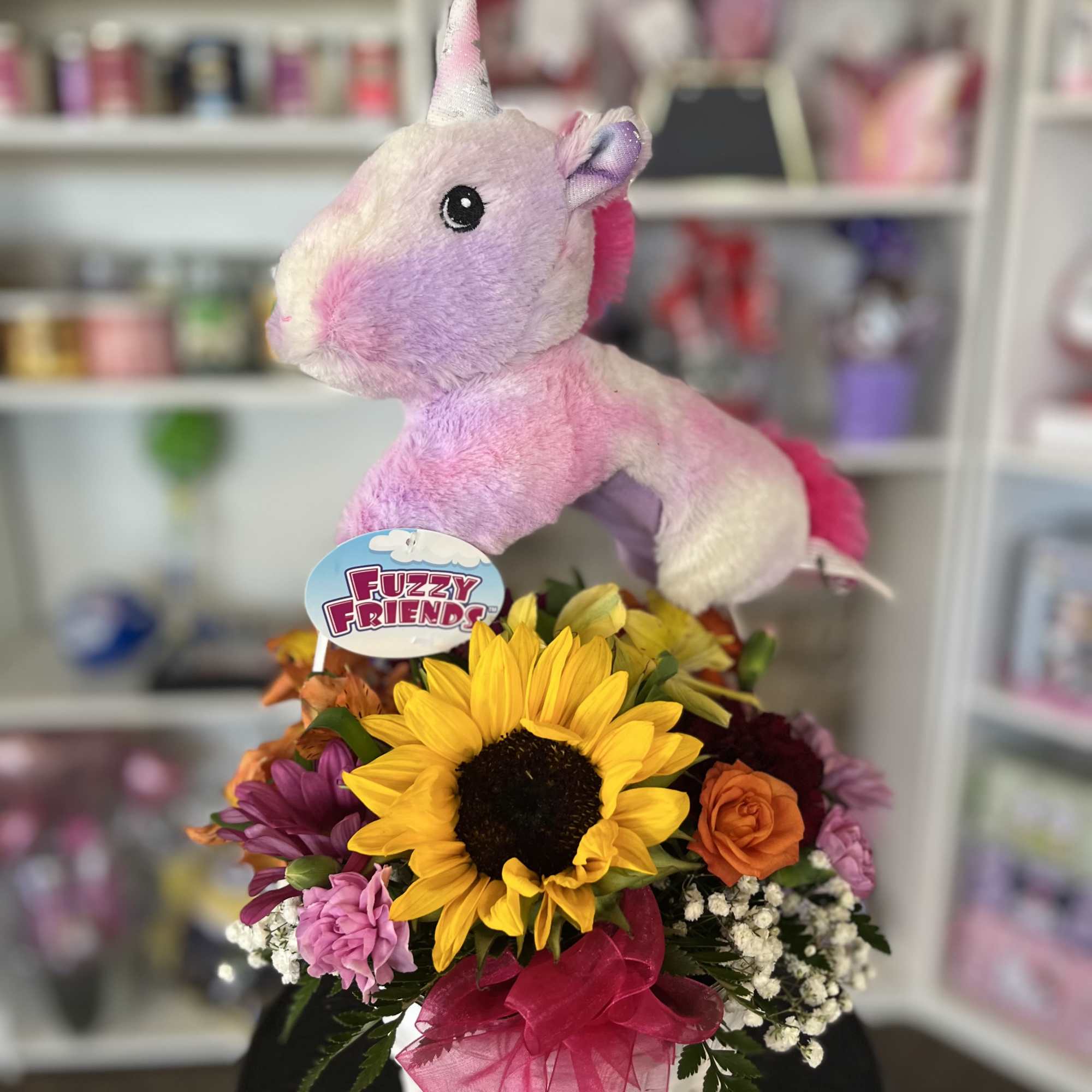 fresh flowers in basket with unicorn plush 
