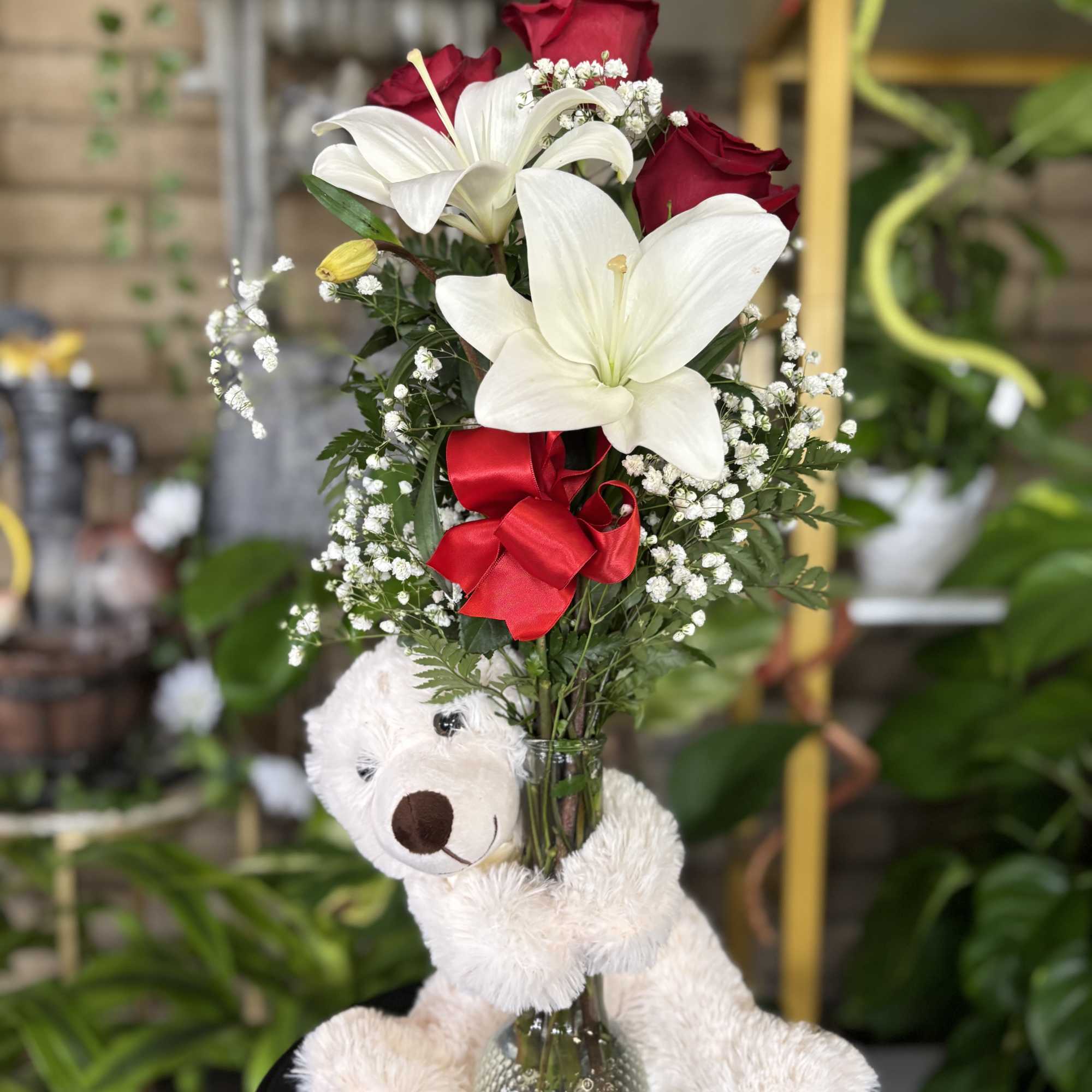 Three red roses and white lilies in bud base with large white
