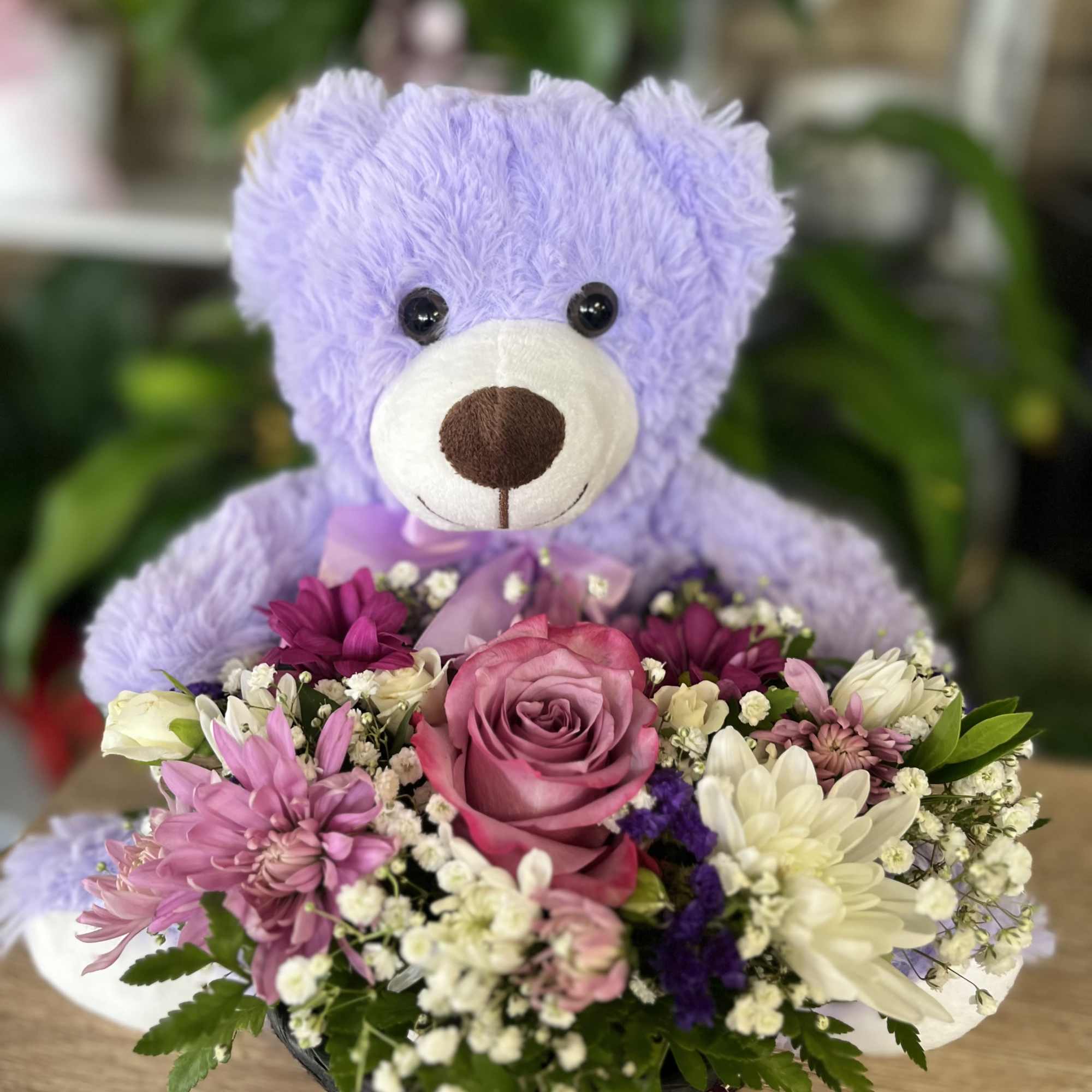 Bear  attach to basket with flowers 