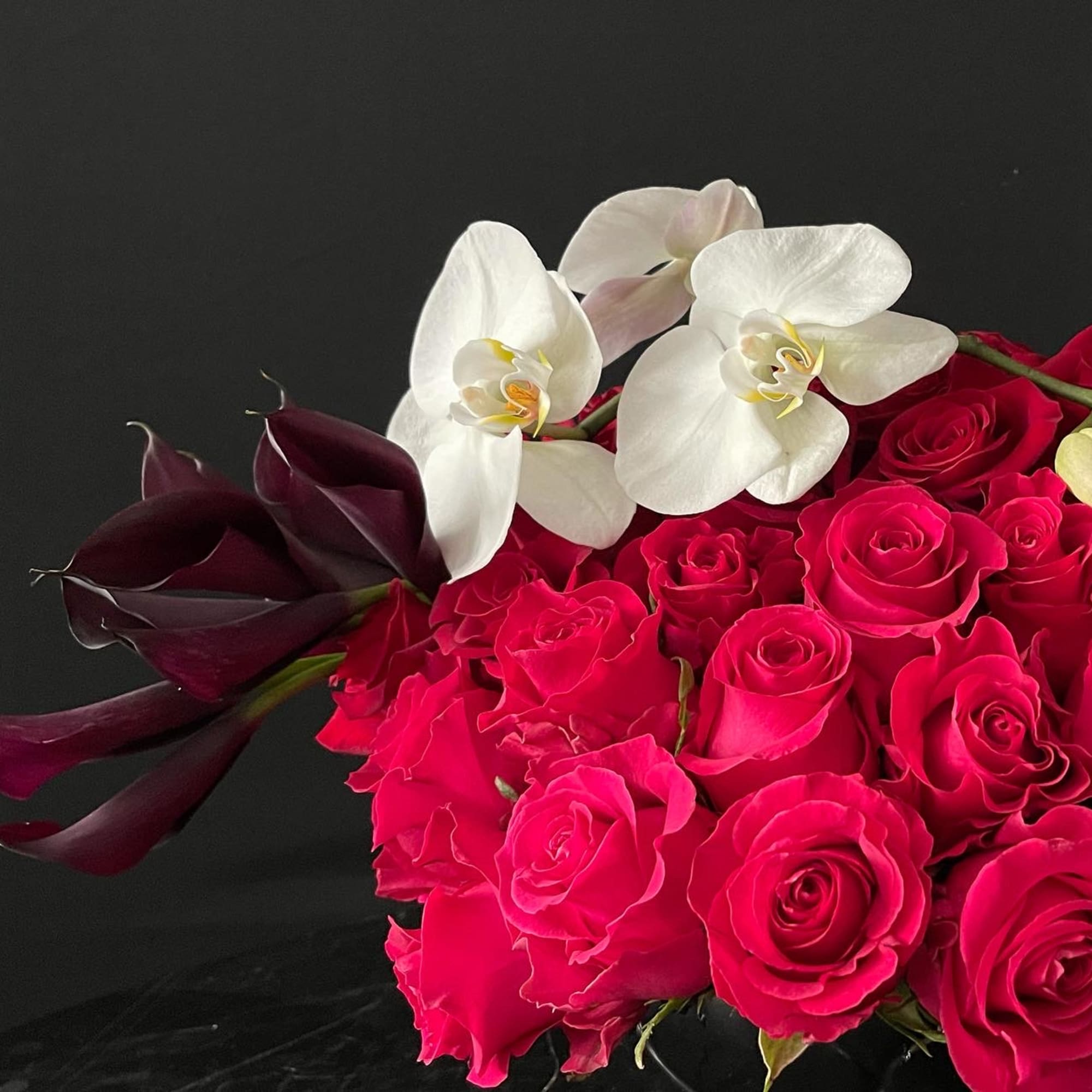 60 Red roses with one orchid stem and 10 romantic dark callas