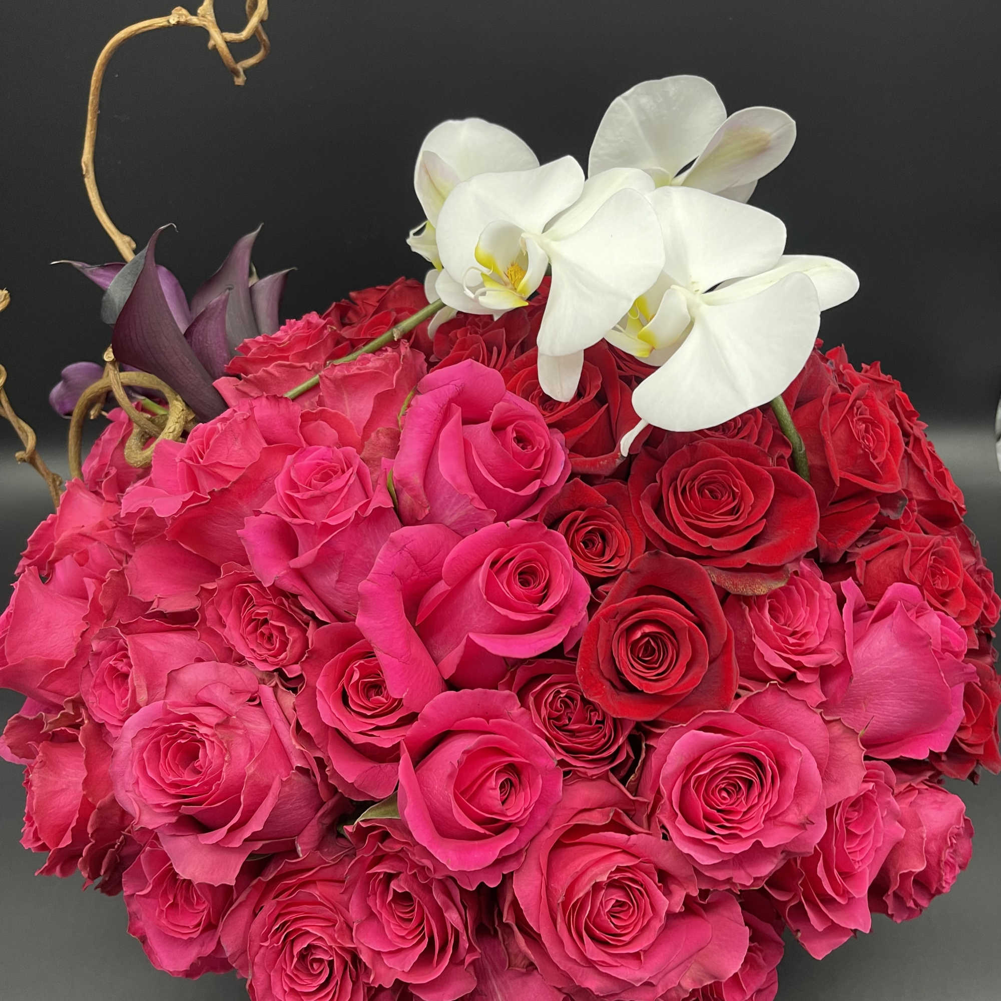 60 Red roses with one orchid stem and 10 romantic dark callas