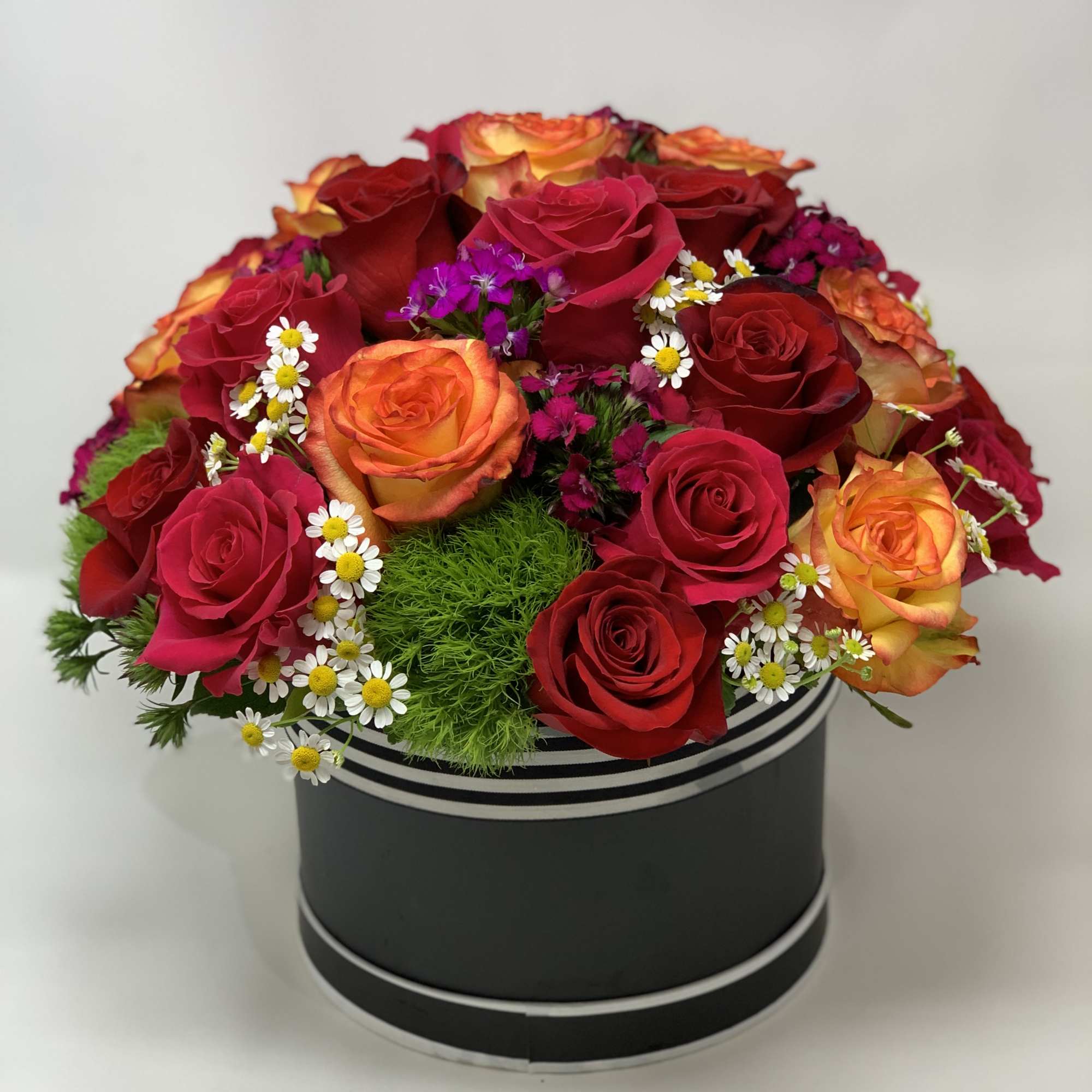 Box of roses with fillers and greens. 