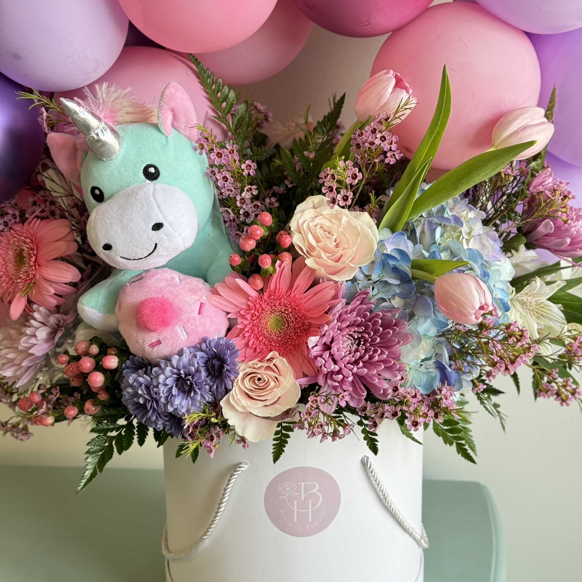 Give the all-in-one gift of balloons, flowers and a plush unicorn that