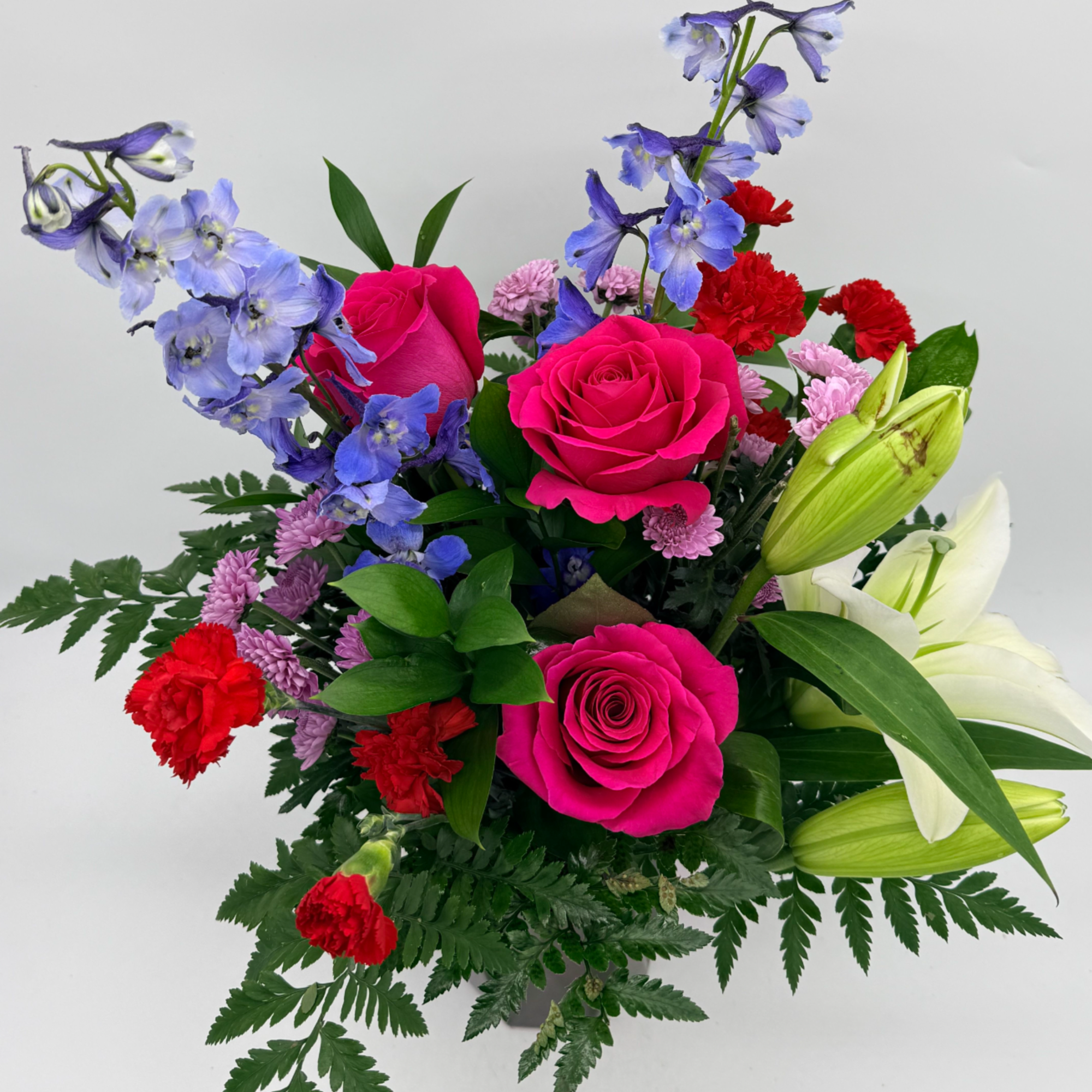 A bright and heartfelt mix of roses, lilies, accent flowers, and fresh