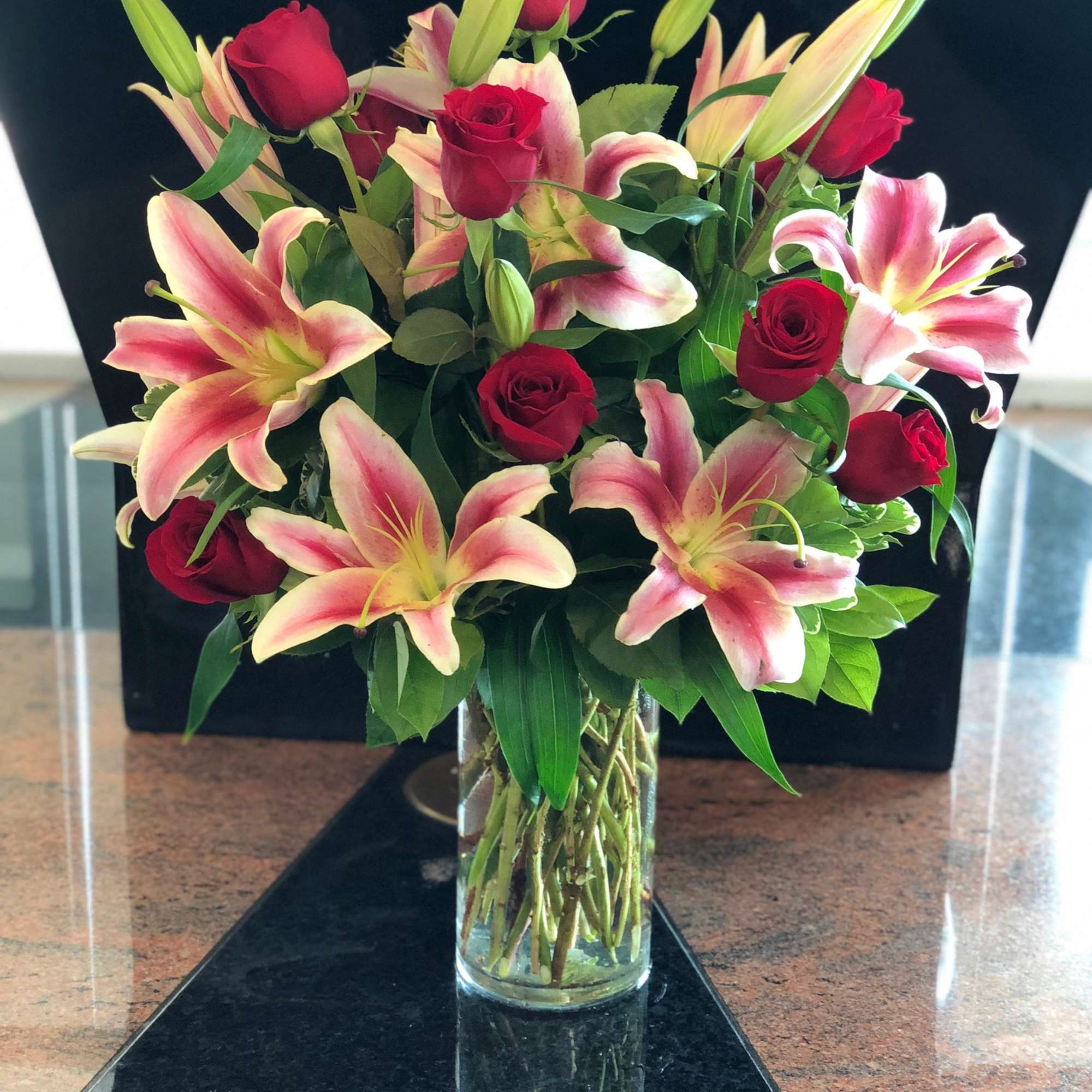 ALLYSON BY TWIN TOWERS FLORIST

10 long-stem premium red roses and 6 stargazer