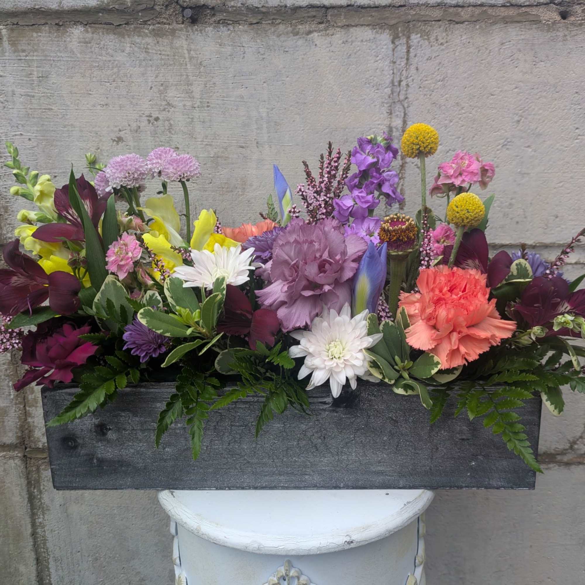 Bursting with color, texture, and seasonal charm, this thoughtfully curated arrangement is