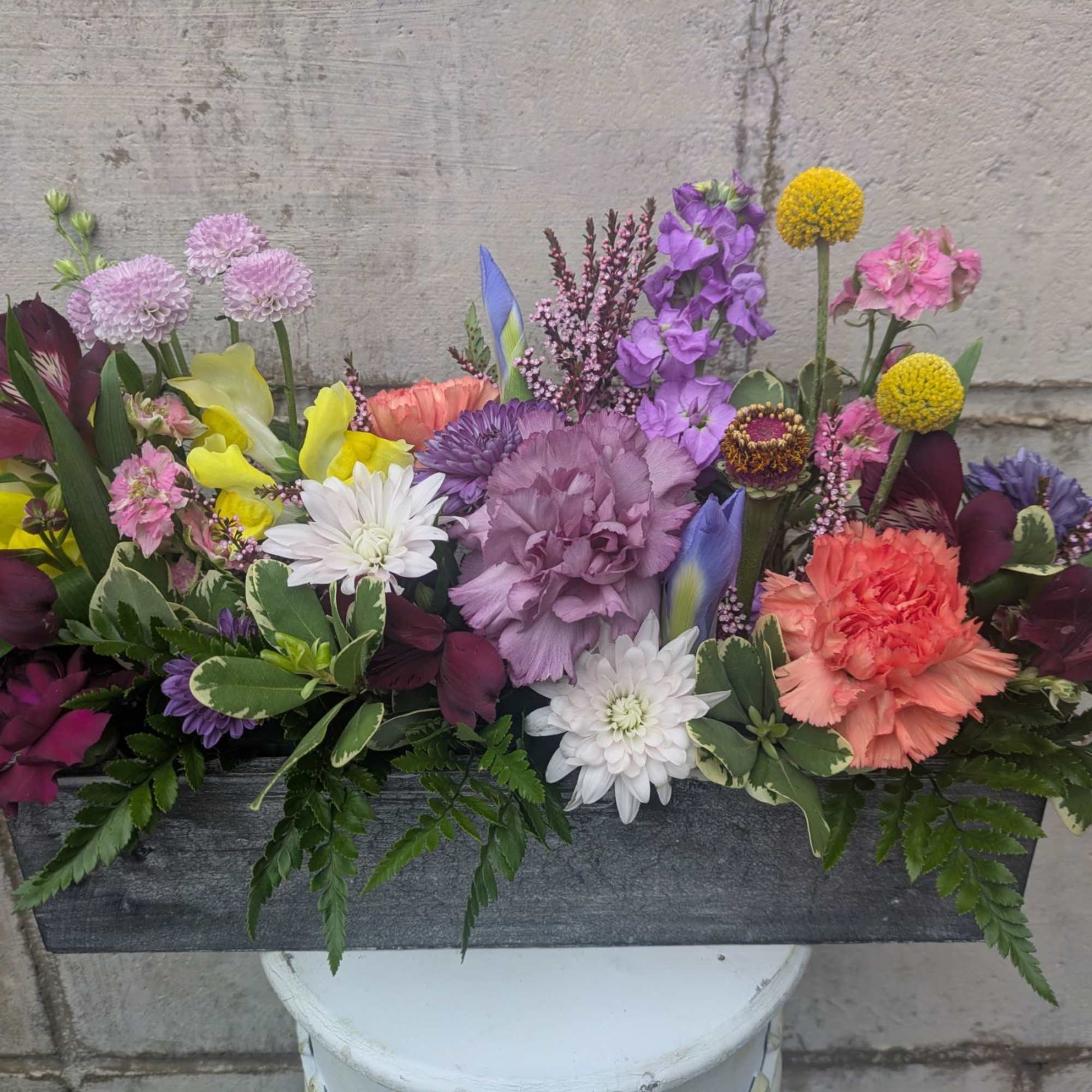 Bursting with color, texture, and seasonal charm, this thoughtfully curated arrangement is