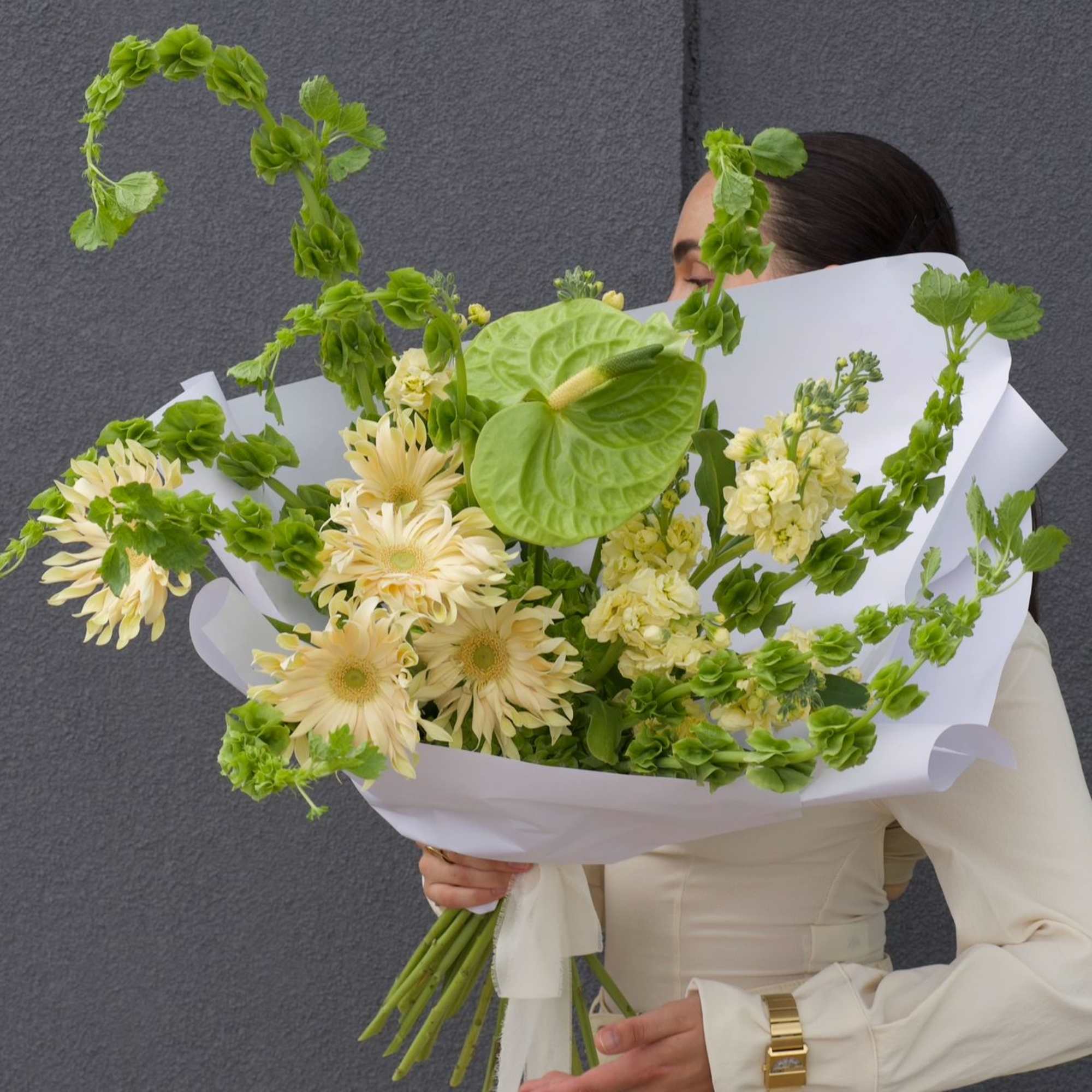 A fresh and modern bouquet in a soft lime-green palette. 
Featuring playful