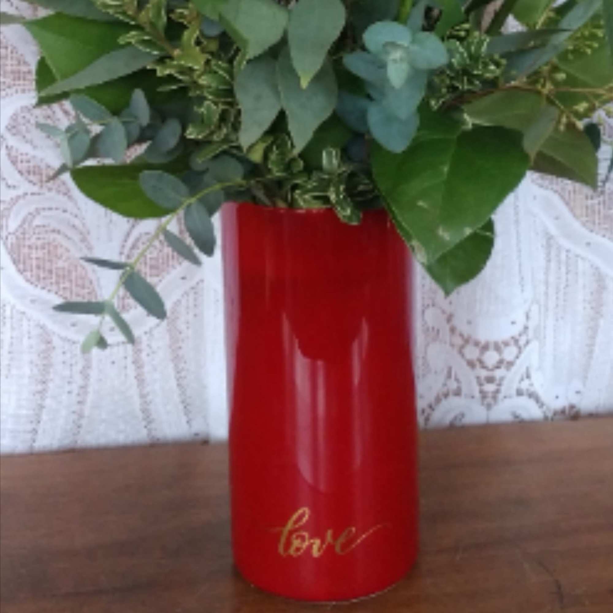 Perfectly romantic, these rich red roses arranged in a red glass cylinder
