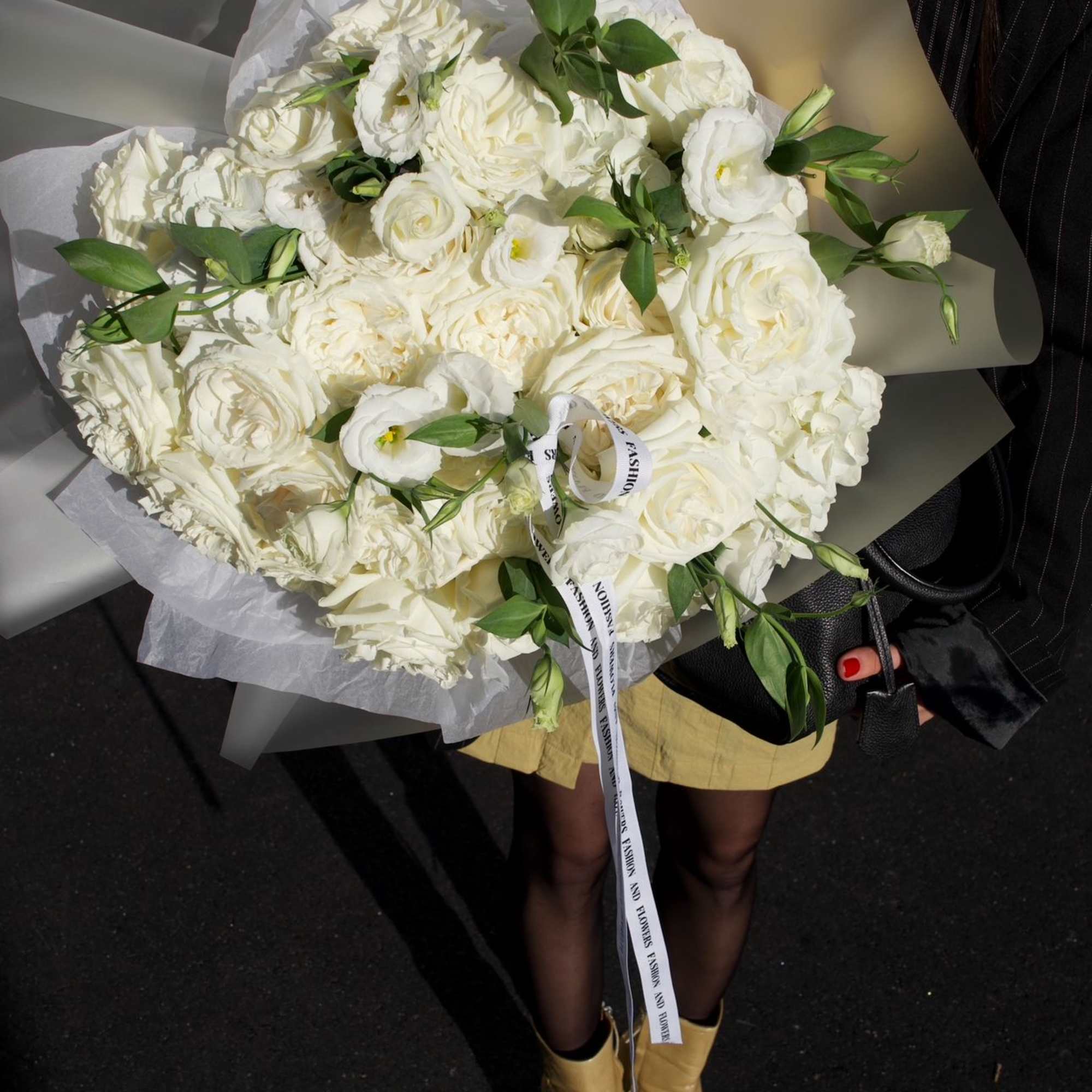 A premium all-white bouquet featuring garden roses, lisianthus, and fresh hydrangea. Designed