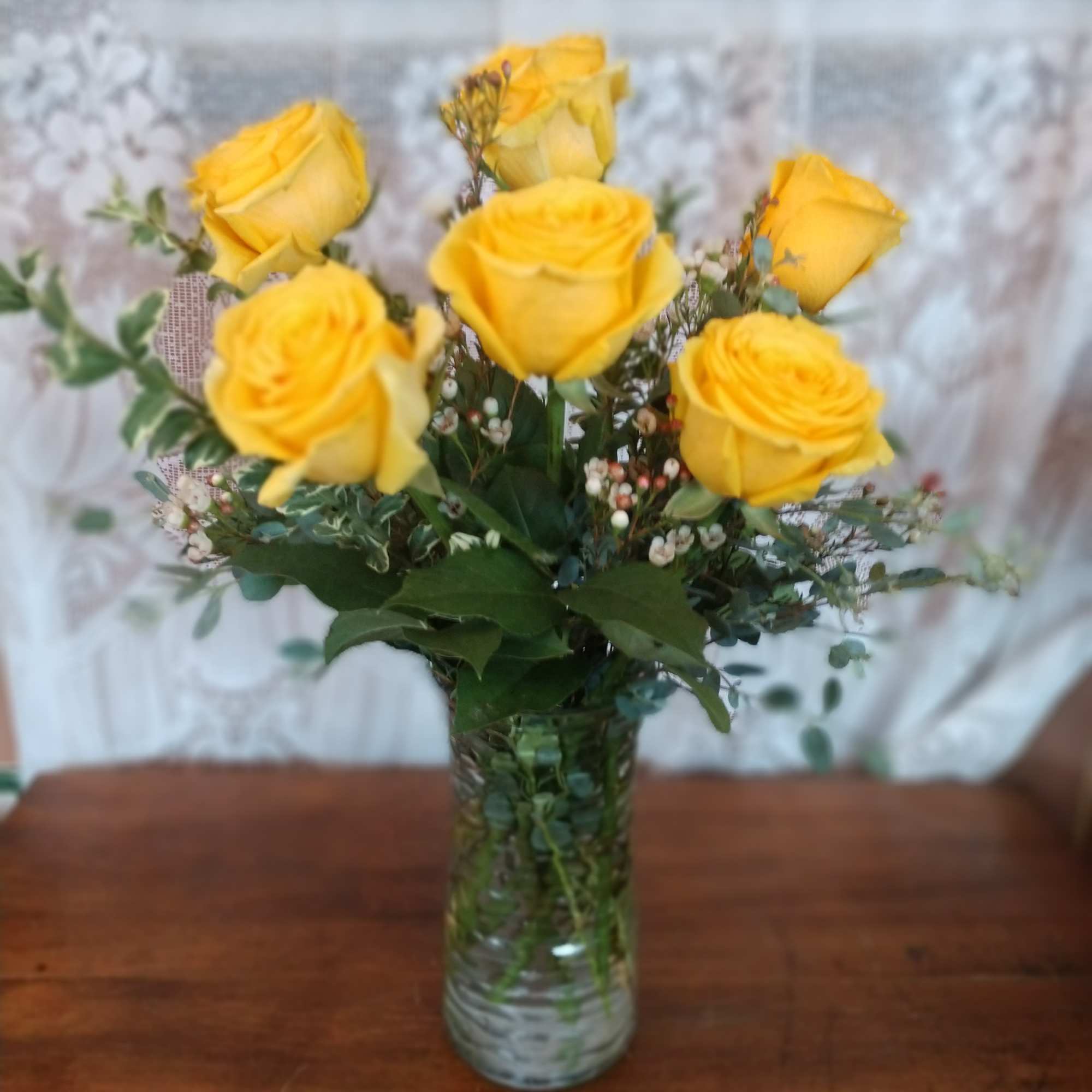 Sunshine yellow roses are sure to brighten any ones day. These sunny
