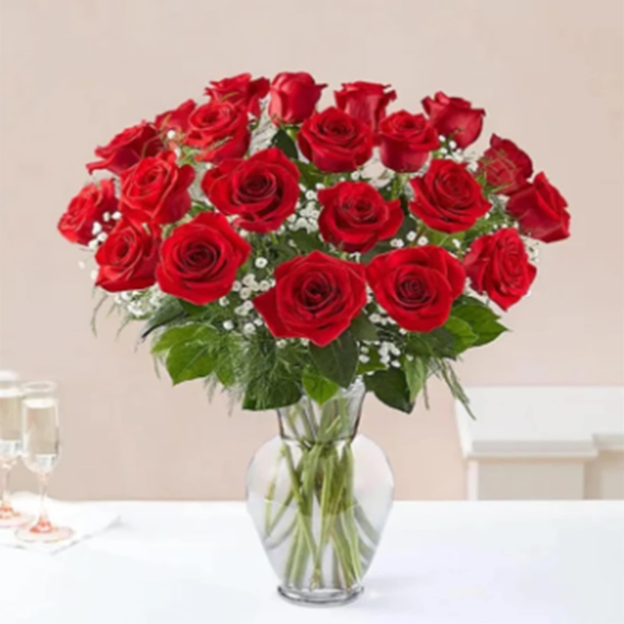 A dozen passionate red roses delicately arranged in a sparkling crystal clear