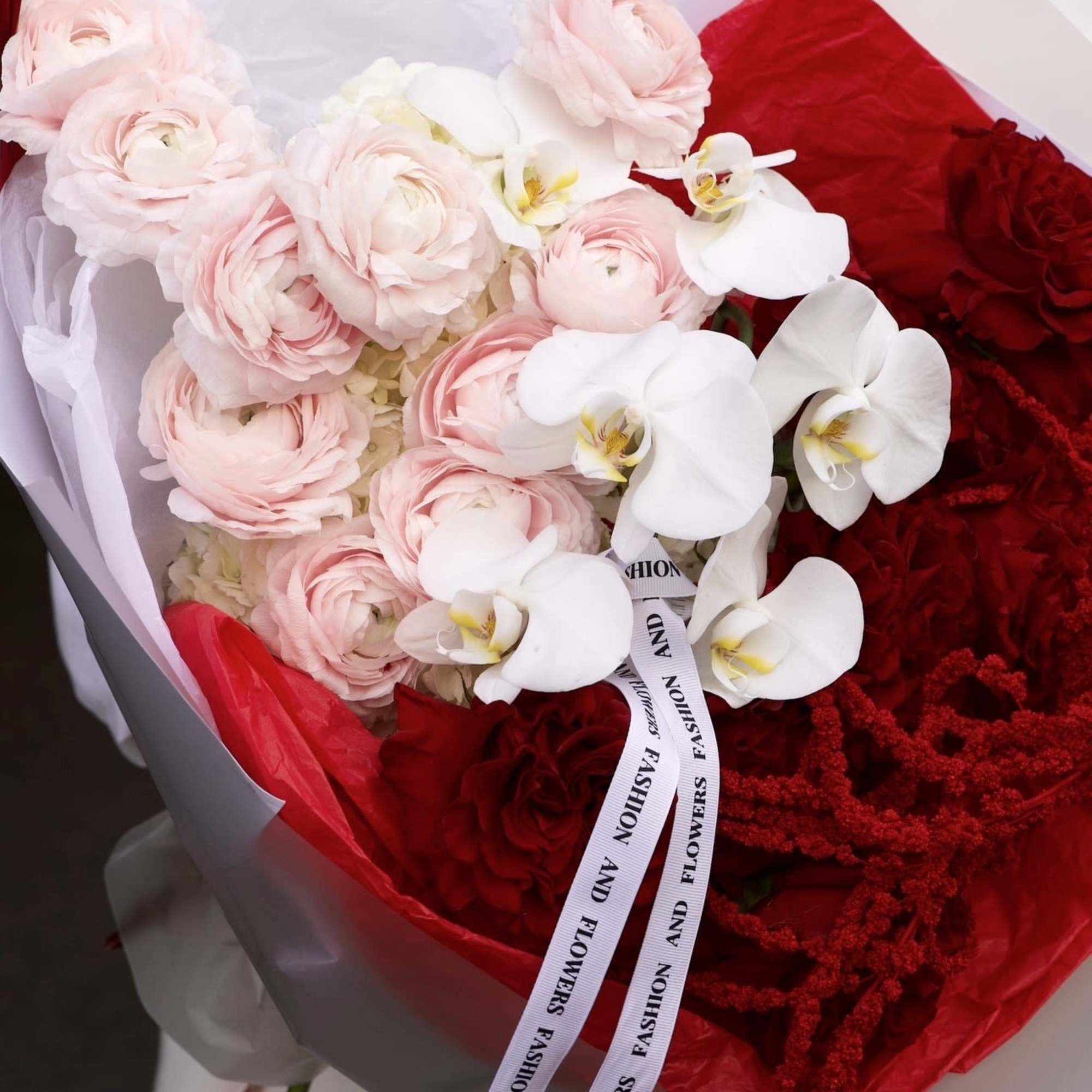 A bold romantic bouquet that plays with contrast &mdash; soft blush ranunculus