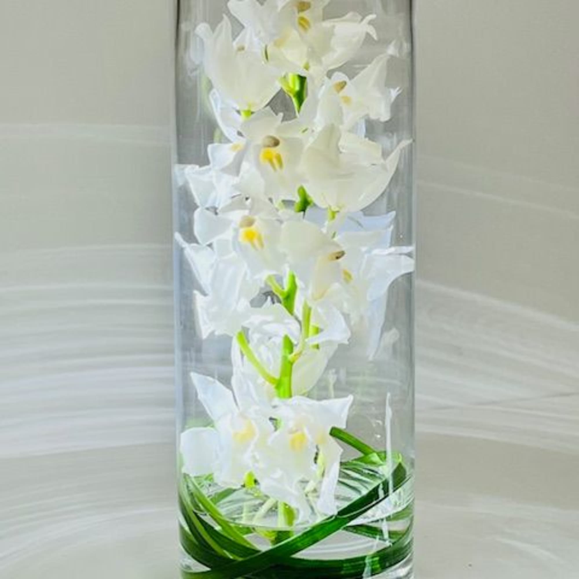 A modern and simplistic arrangement with exotic green cymbidium orchids in a