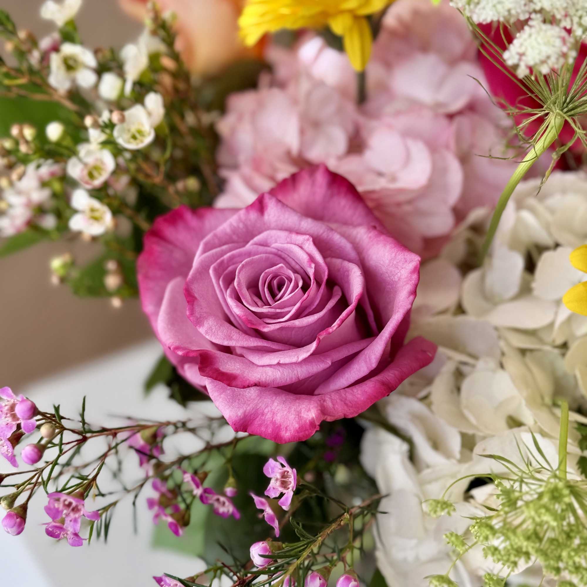 Colorful bunch of flowers in a clear glass vase, made with lots