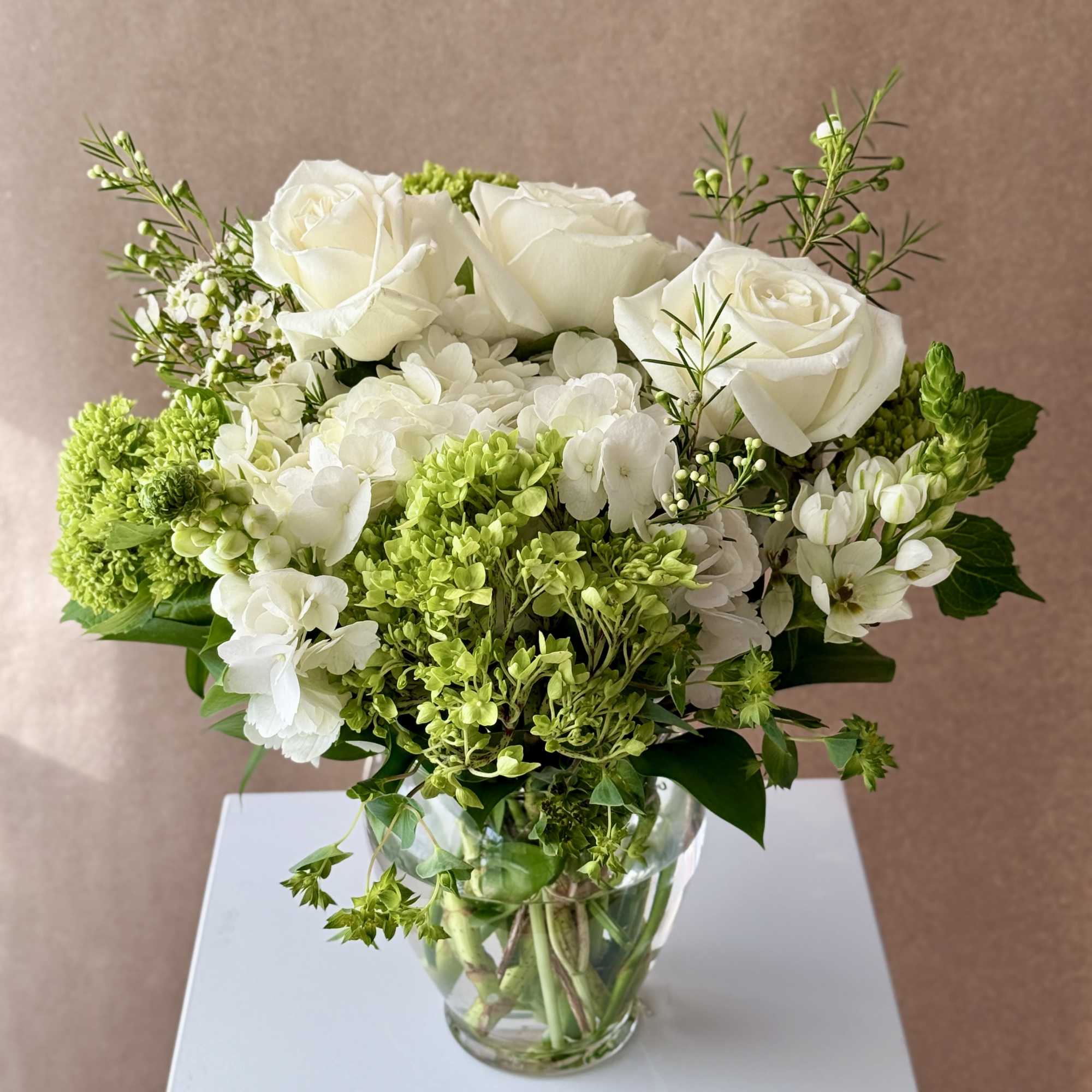 Gentle arrangements with whites and greens. 