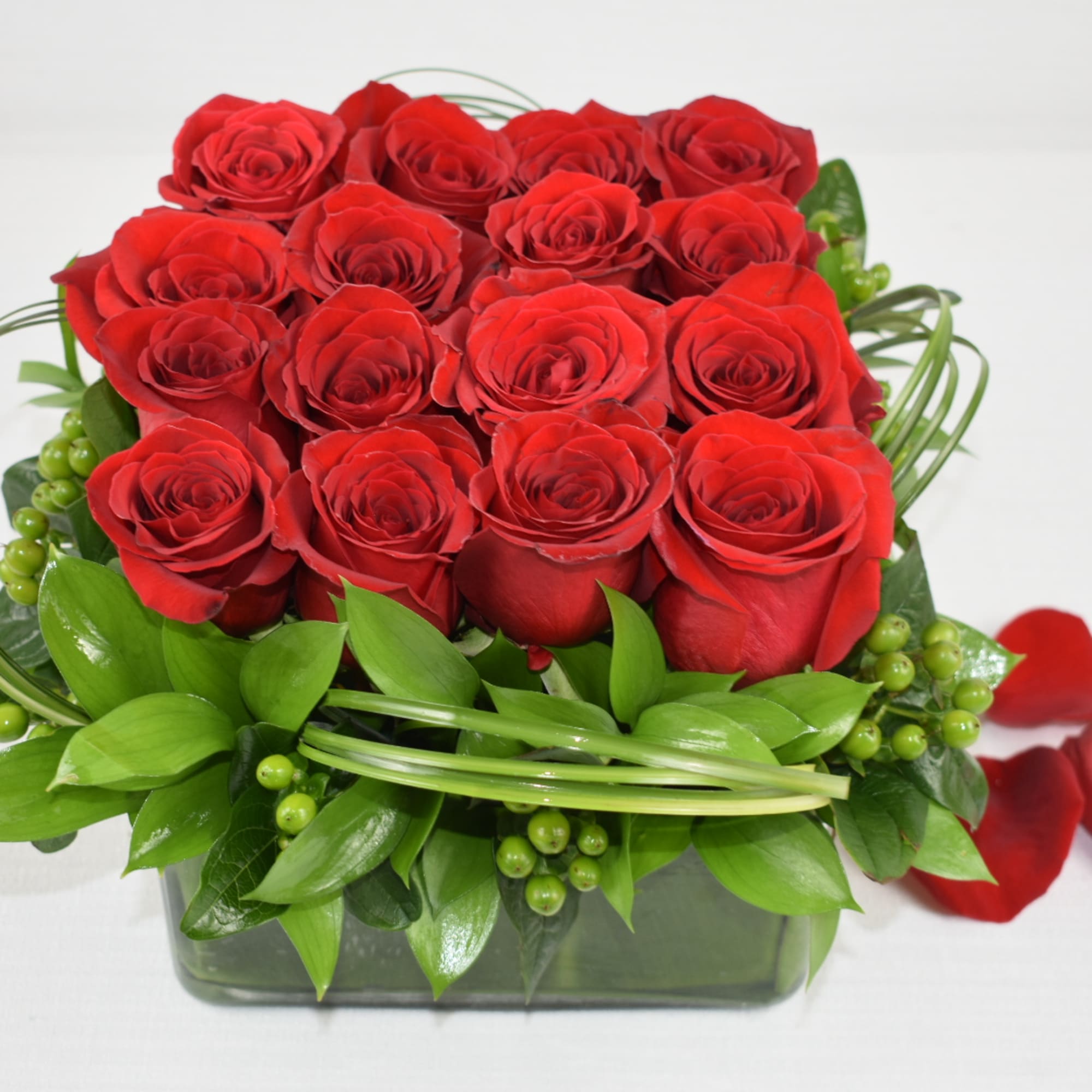 An amazing low arrangement with 16 Ecuadorian roses perfectly combined with some