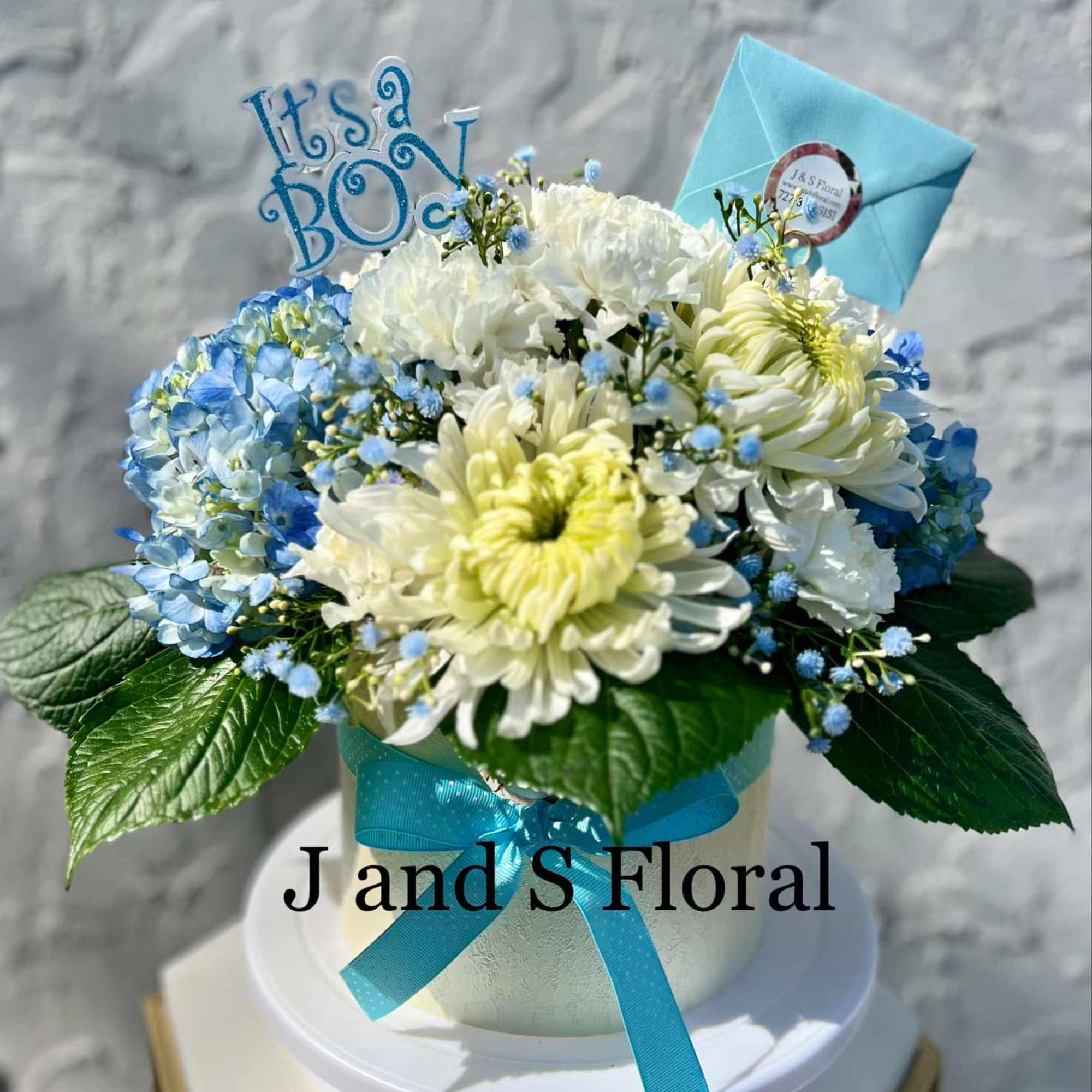 Celebrate the great news with our handcrafted Baby Boy floral arrangement. Perfect