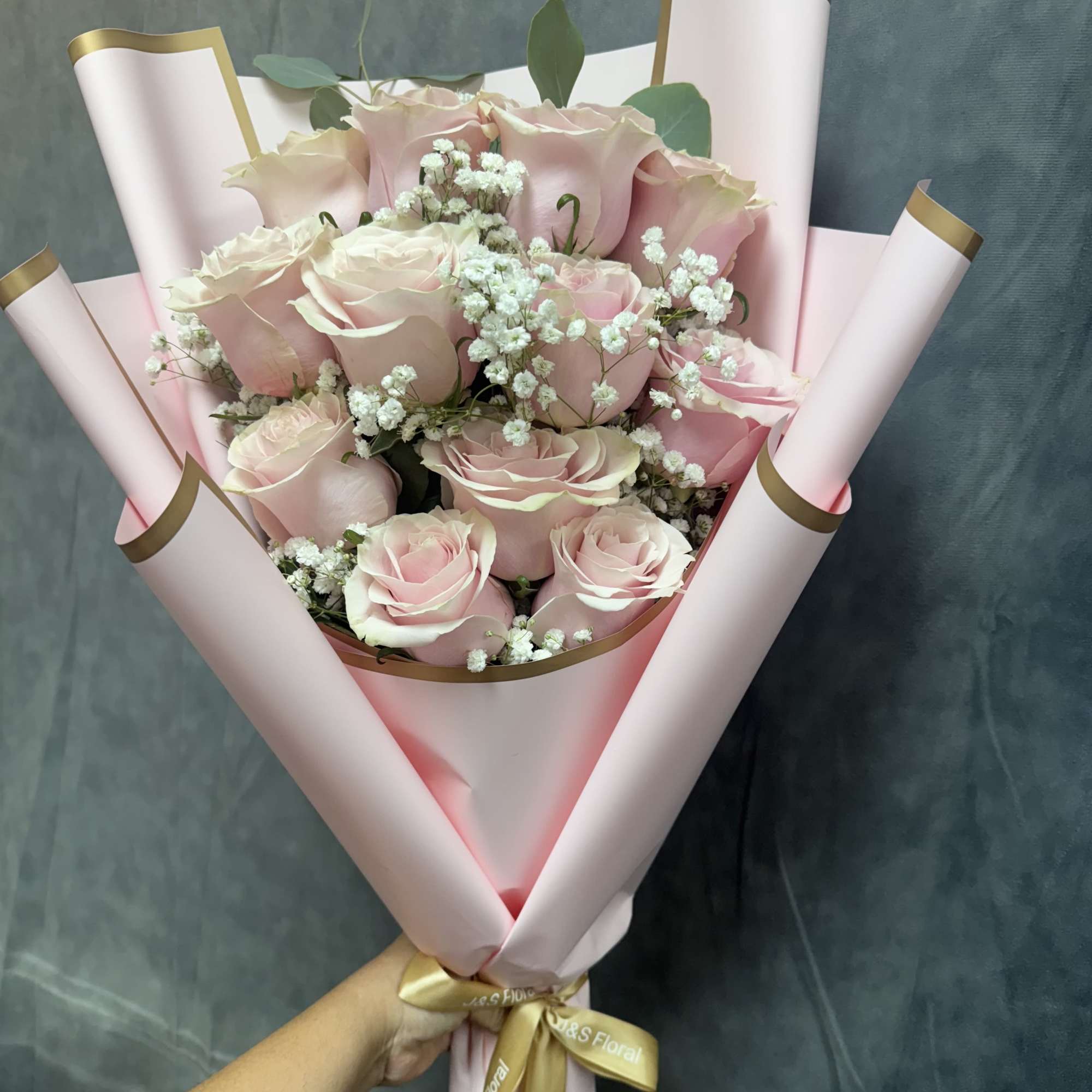 The pink roses bouquet is a charming and elegant floral arrangement featuring