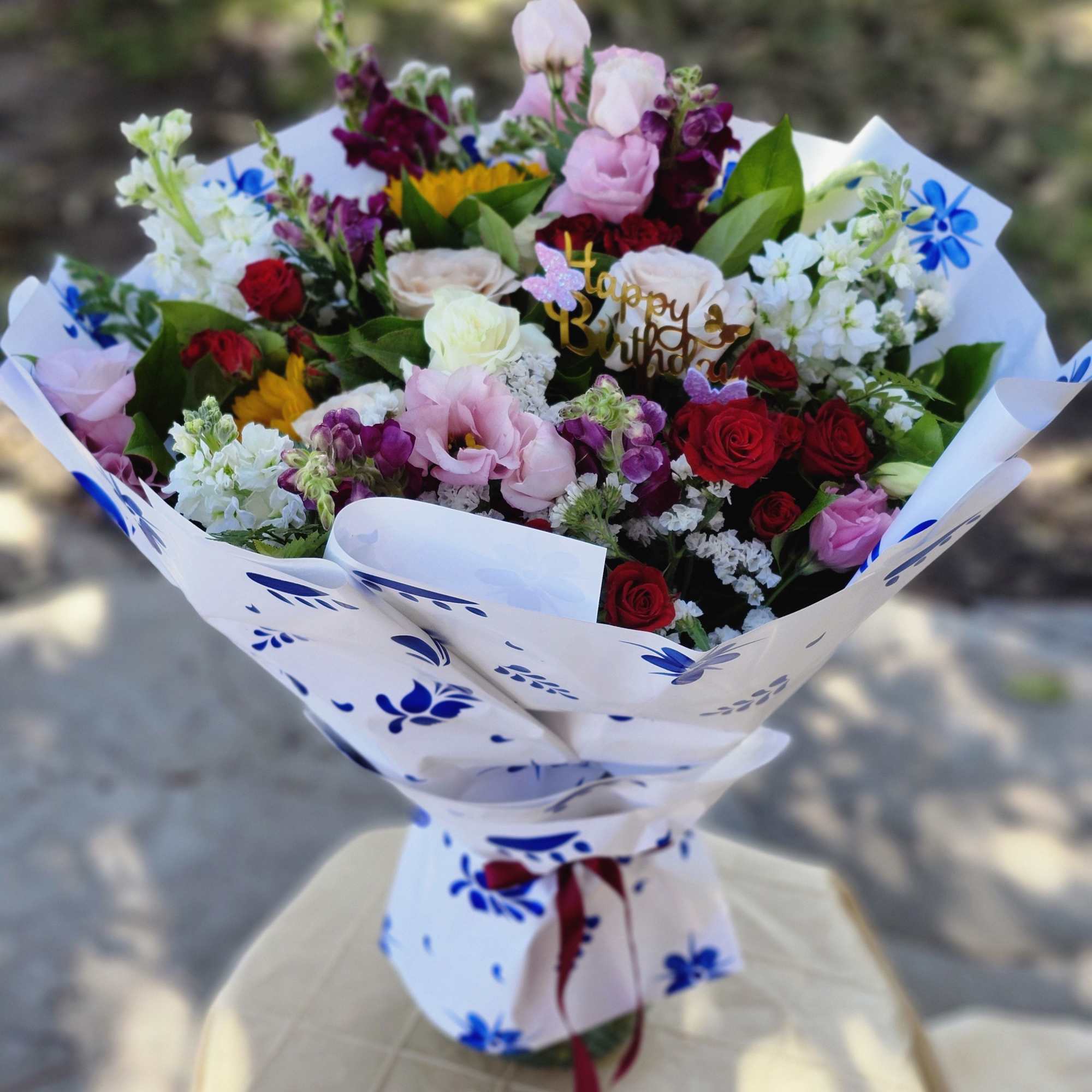 Designer's Choice Wrap Bouquet in vibrant colors in season florals. Ready to