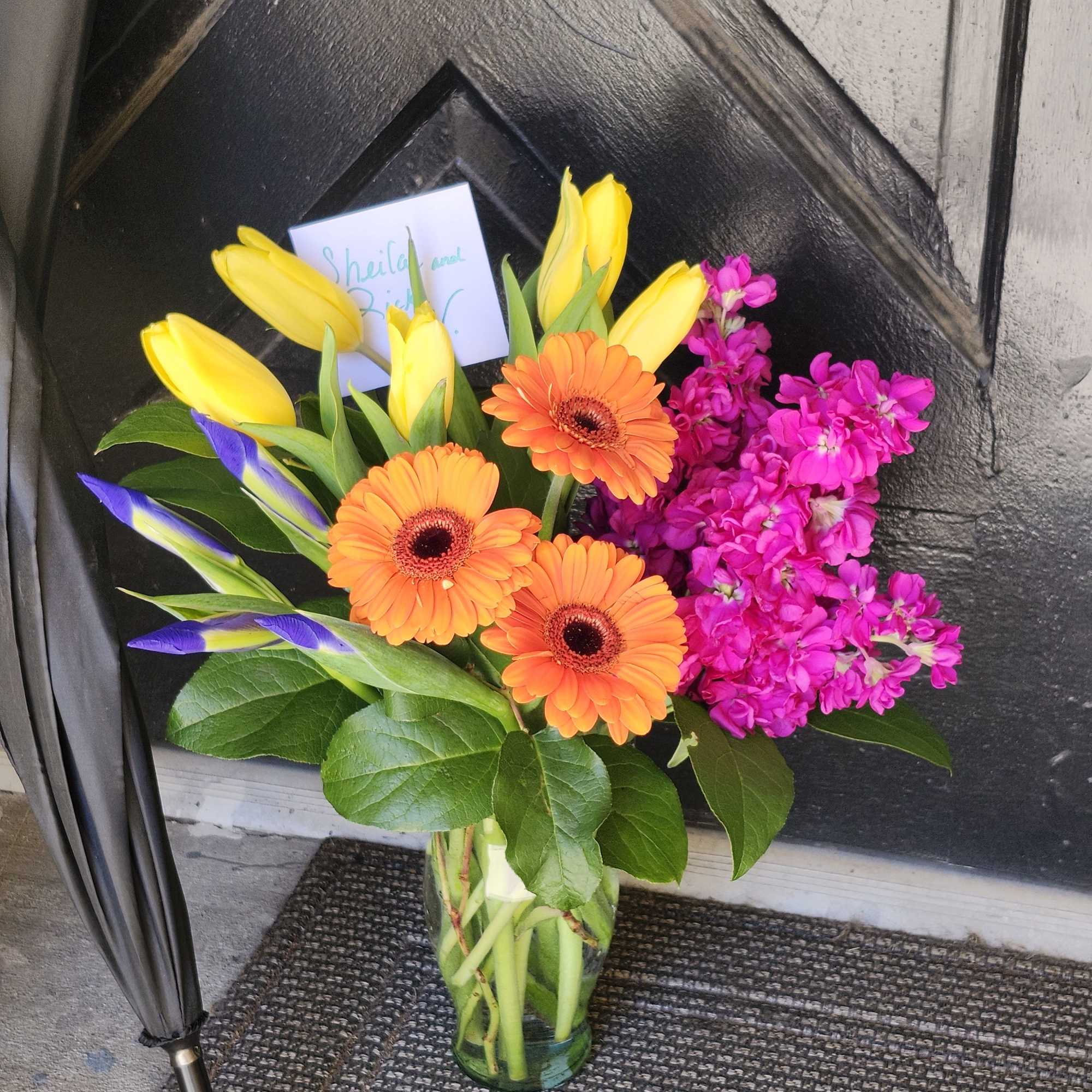 Featuring daisies, tulips, iris, and stock this petite arrangement is a fun