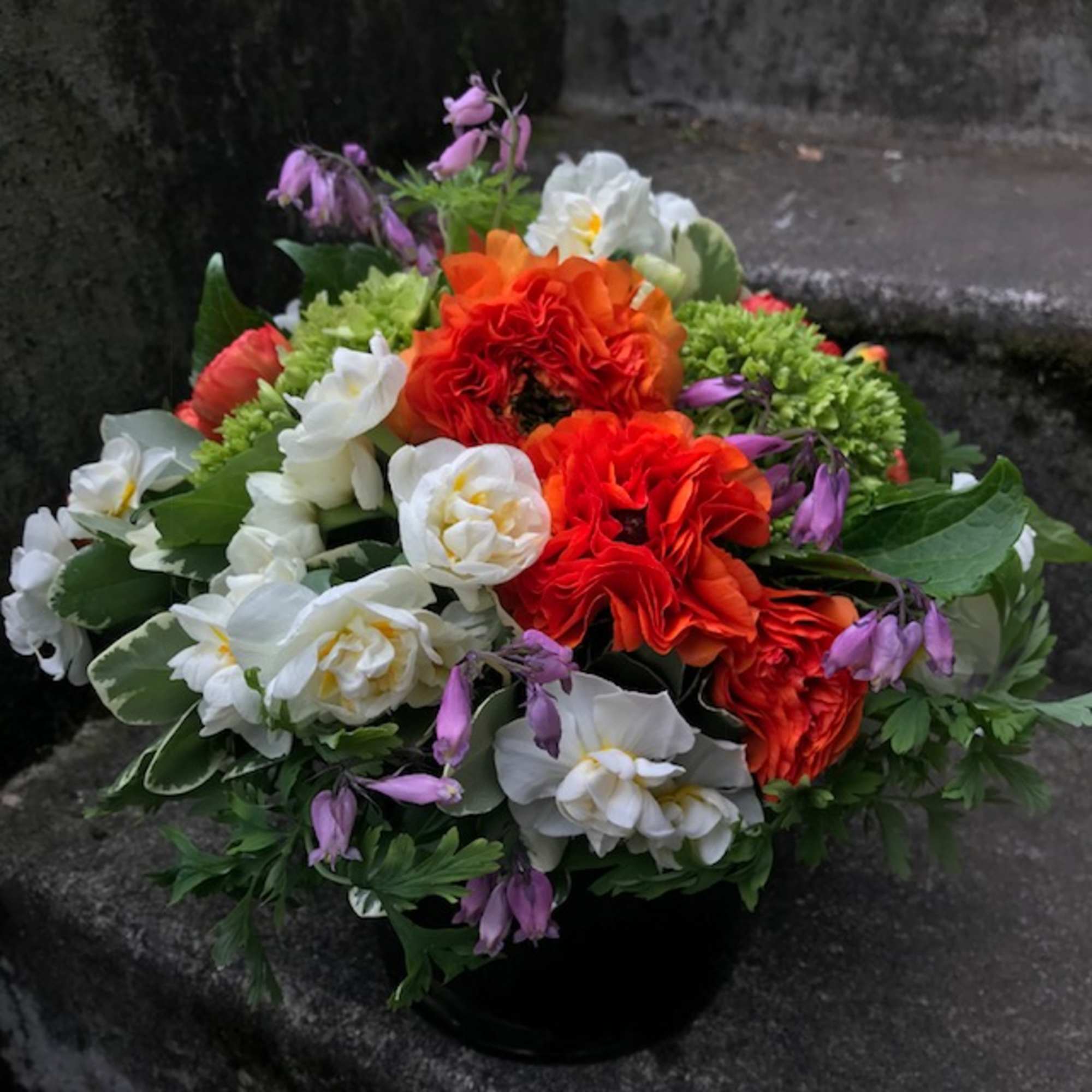 A medium-size floral arrangement that will not overwhelm a desk or coffee