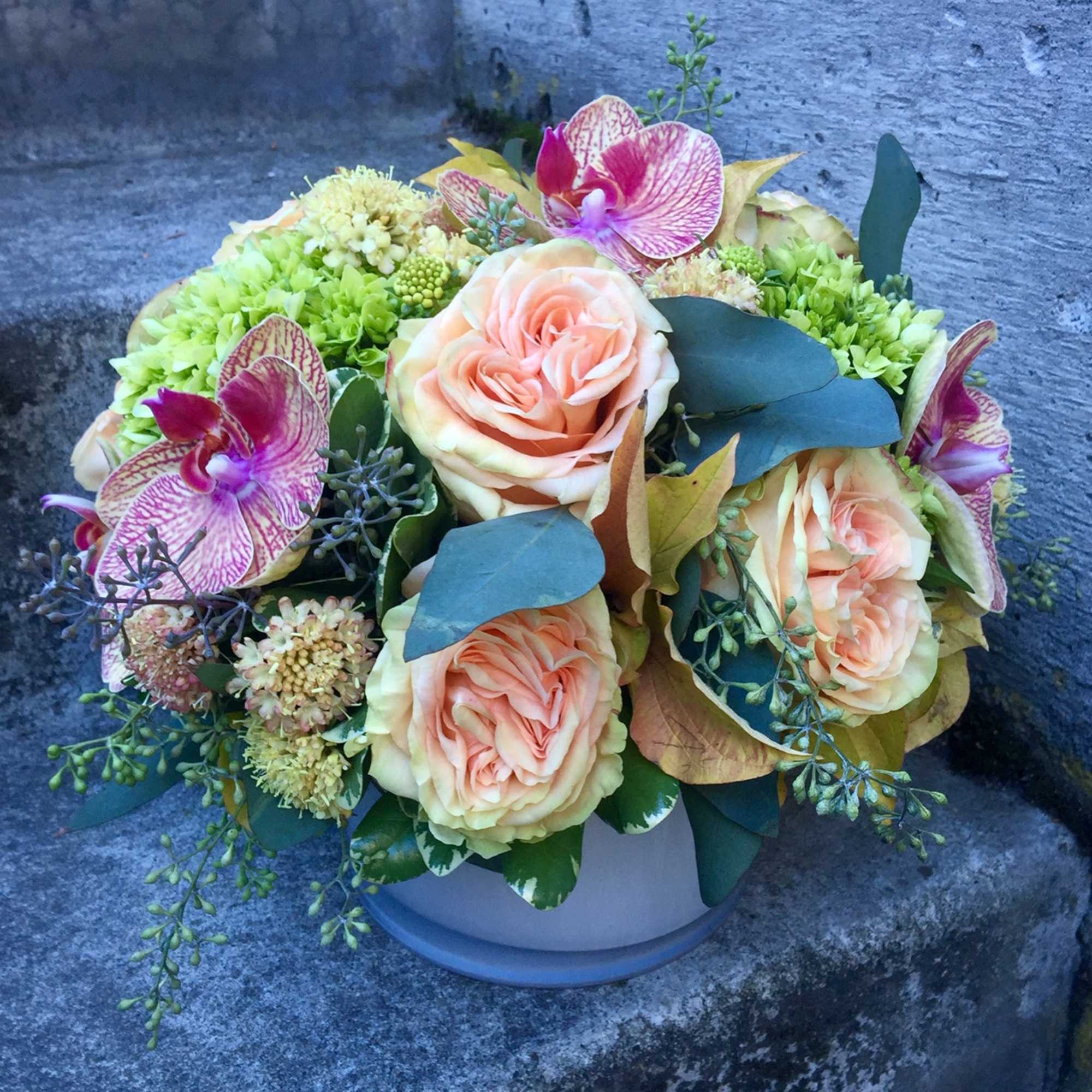 A medium-size floral arrangement that will not overwhelm a desk or coffee