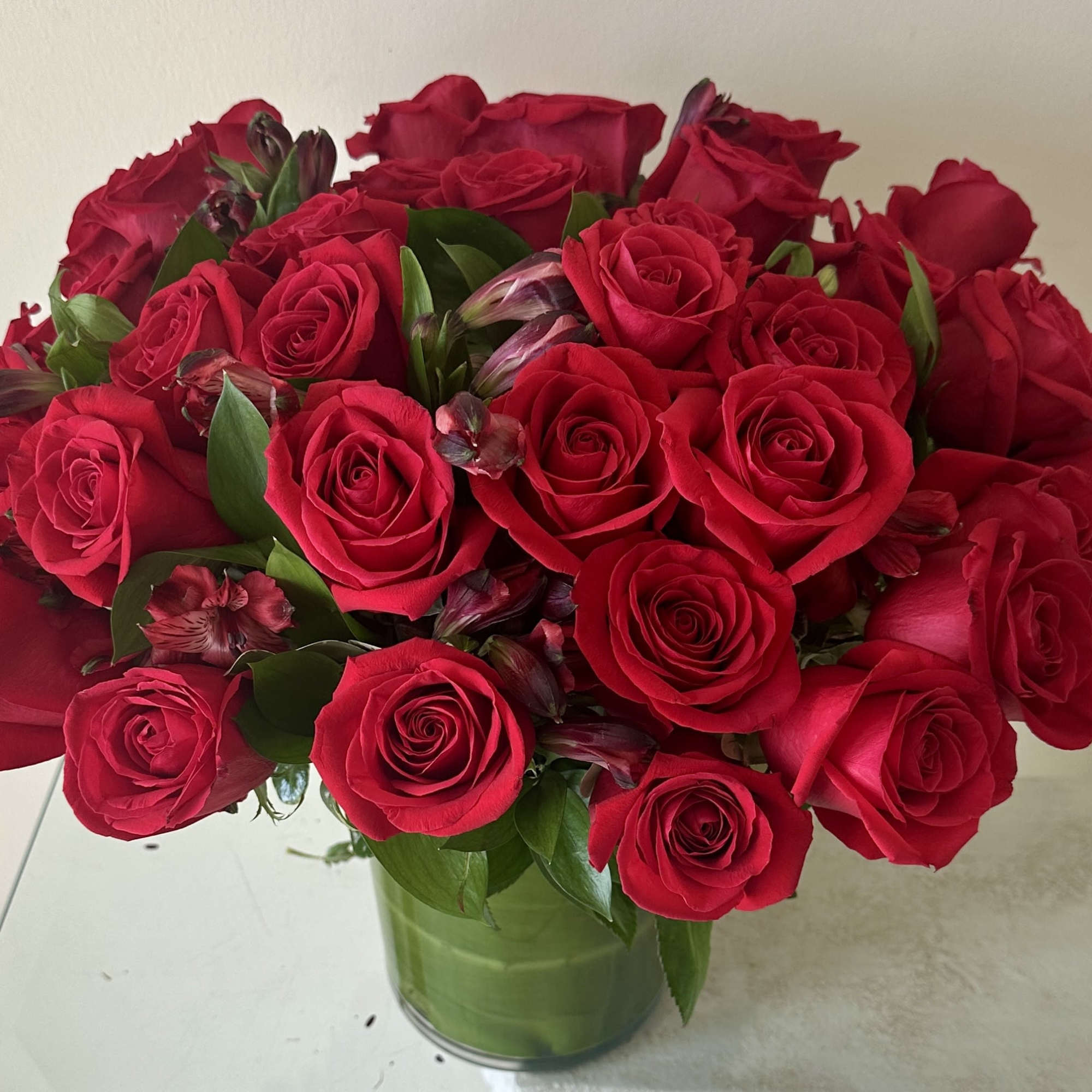 A stunning arrangement of 36 select red roses, artfully designed in a