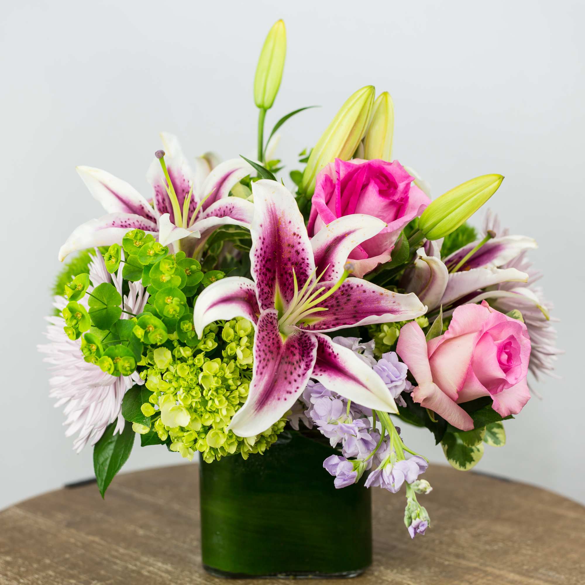 Pink Roses, Green Hydrangea, Spider Mum, Lily, Stock. Flowers and containers availability