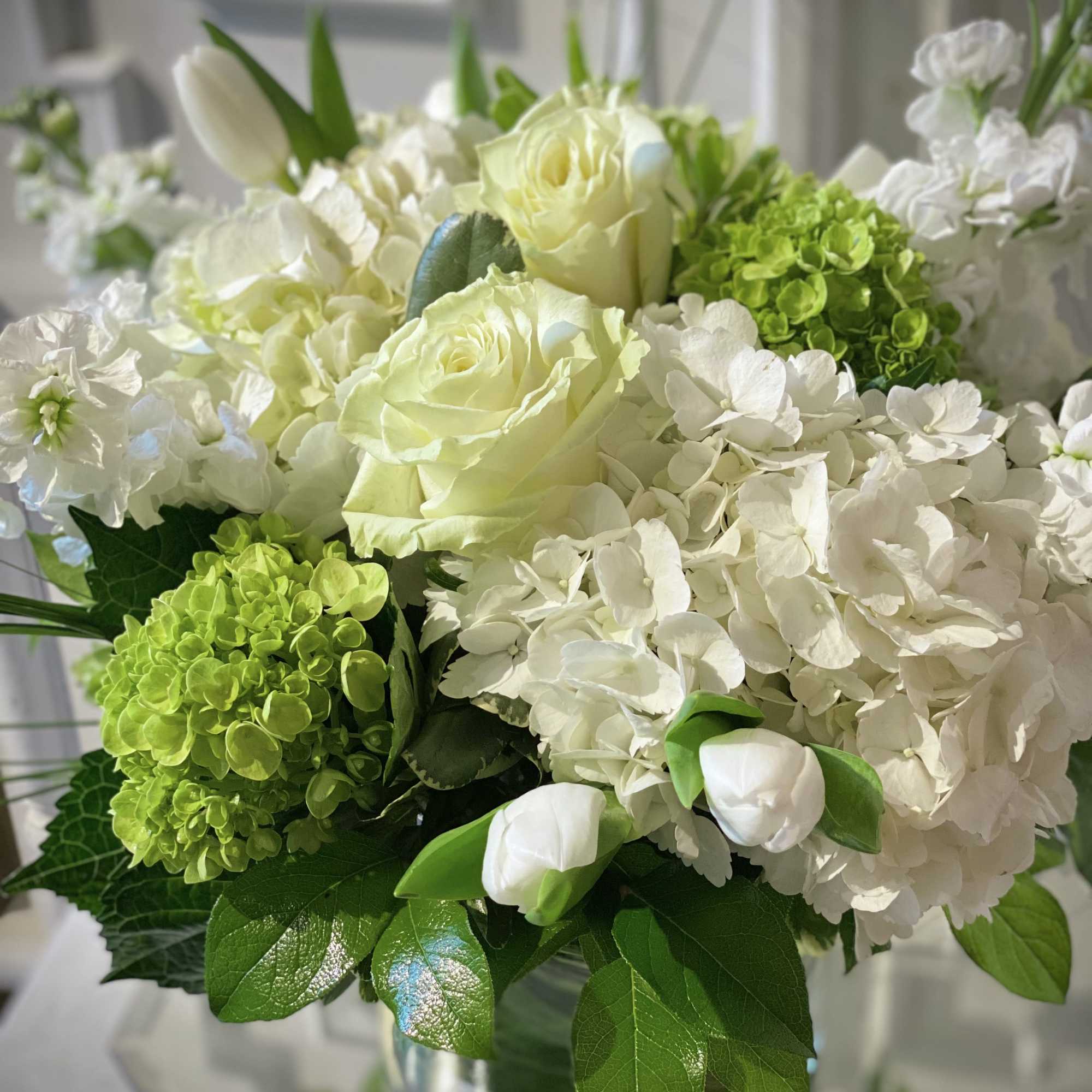Stunning style is captured with a compact design of all white flowers