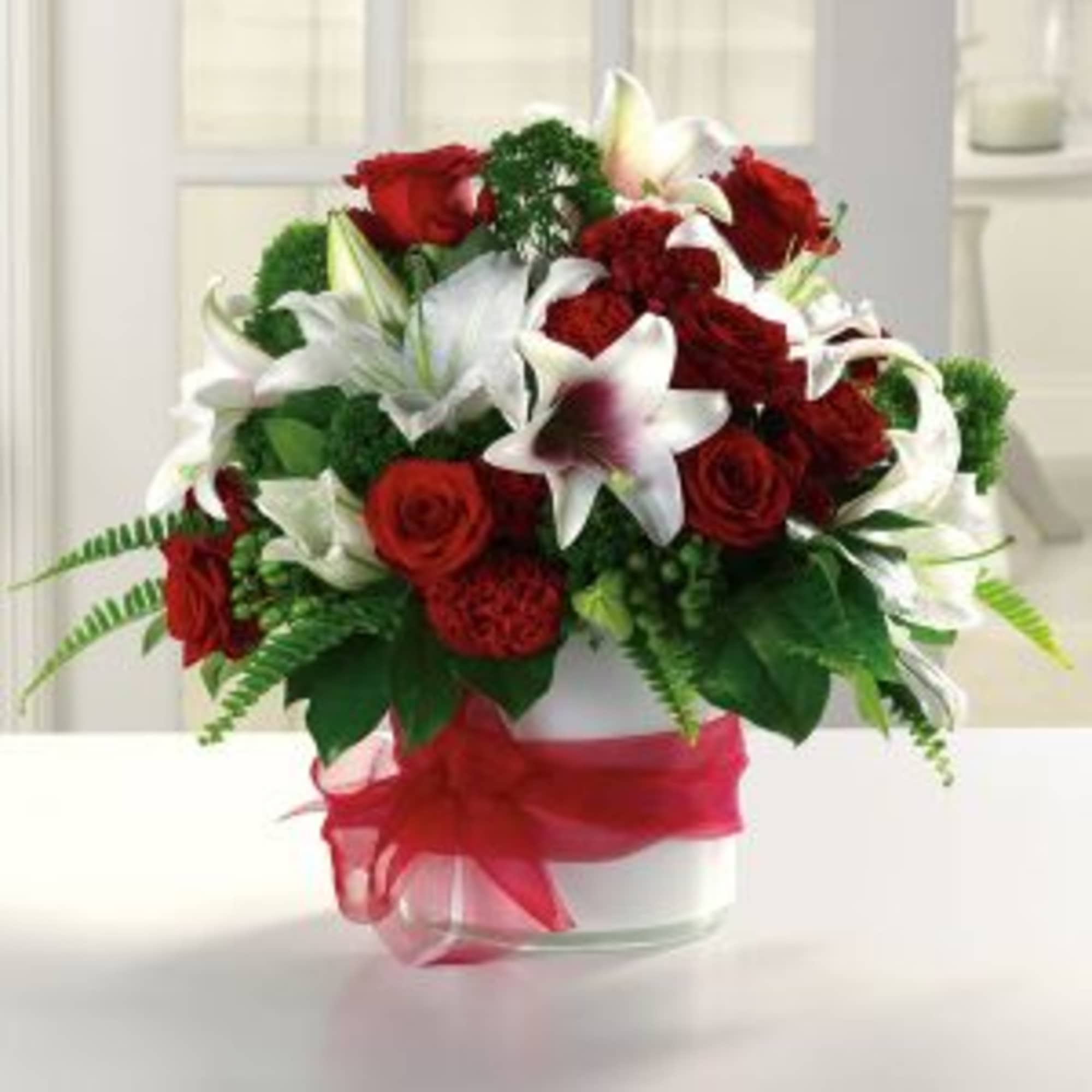 Classic Arrangement of Lillies and red roses, appropriate for any occasion.
Note: This