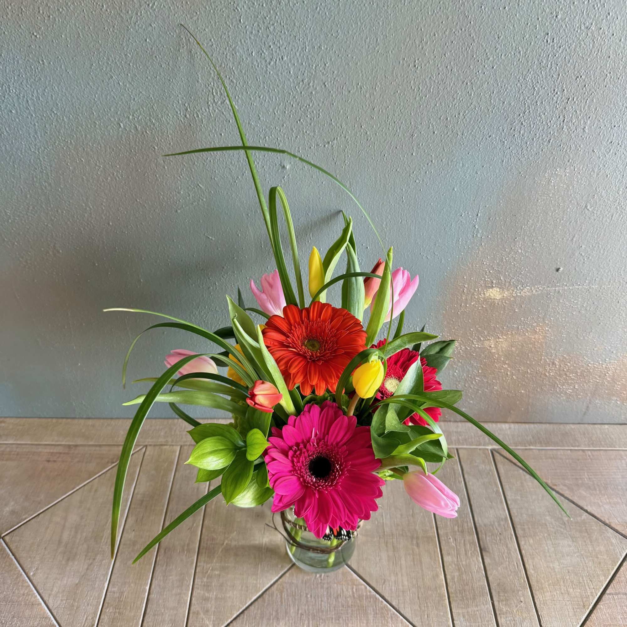 Embrace whimsy with this fun arrangement in bright colors!