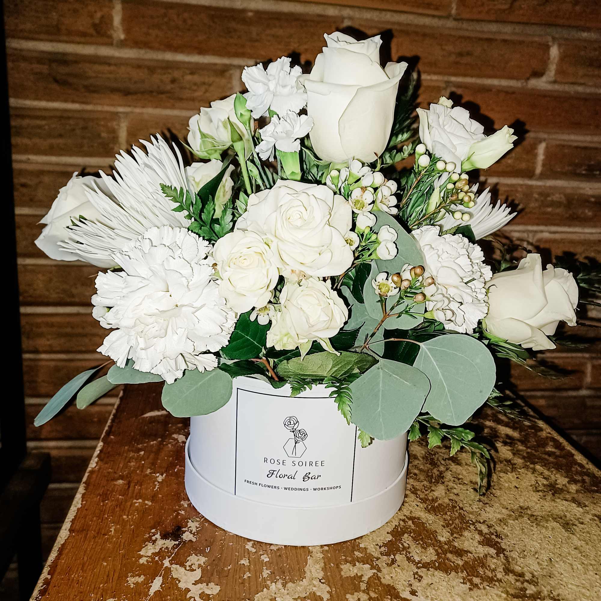 A white Rose Soiree hat box filled to the brim with beautifull