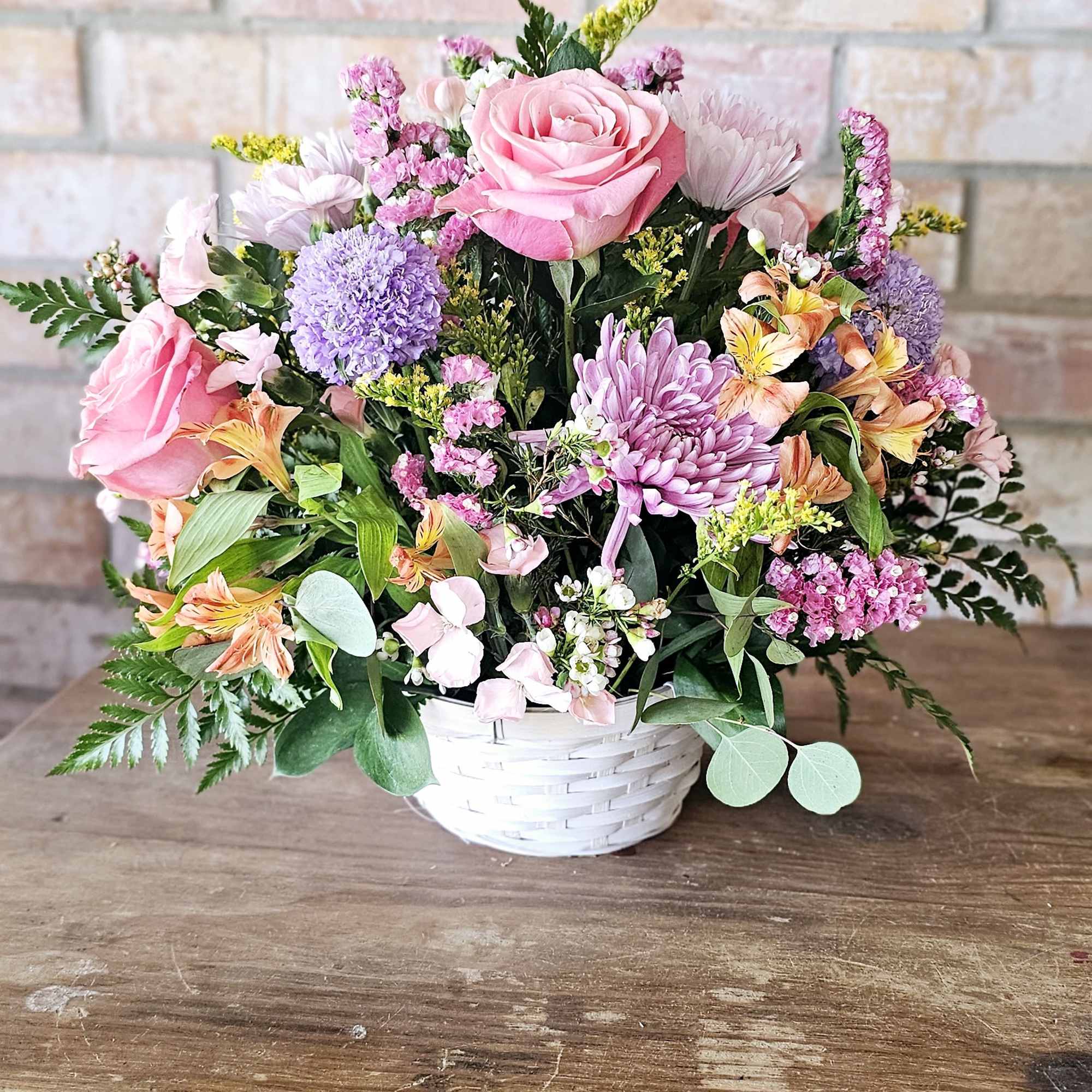 Absolutely adorable basket holds gorgeous spring hue's of flowers. A great gift