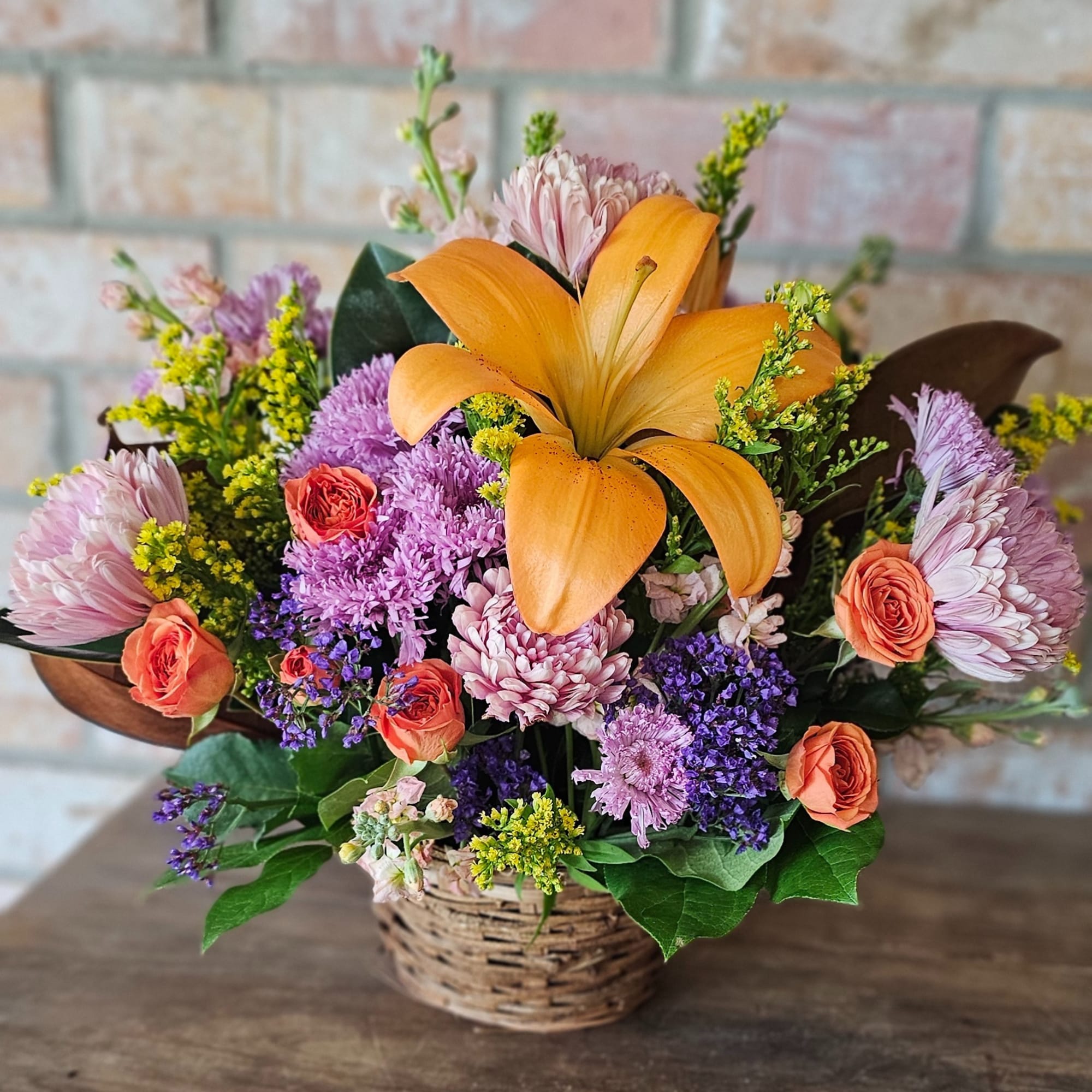 Absolutely adorable basket holds gorgeous spring hue's of flowers. A great gift