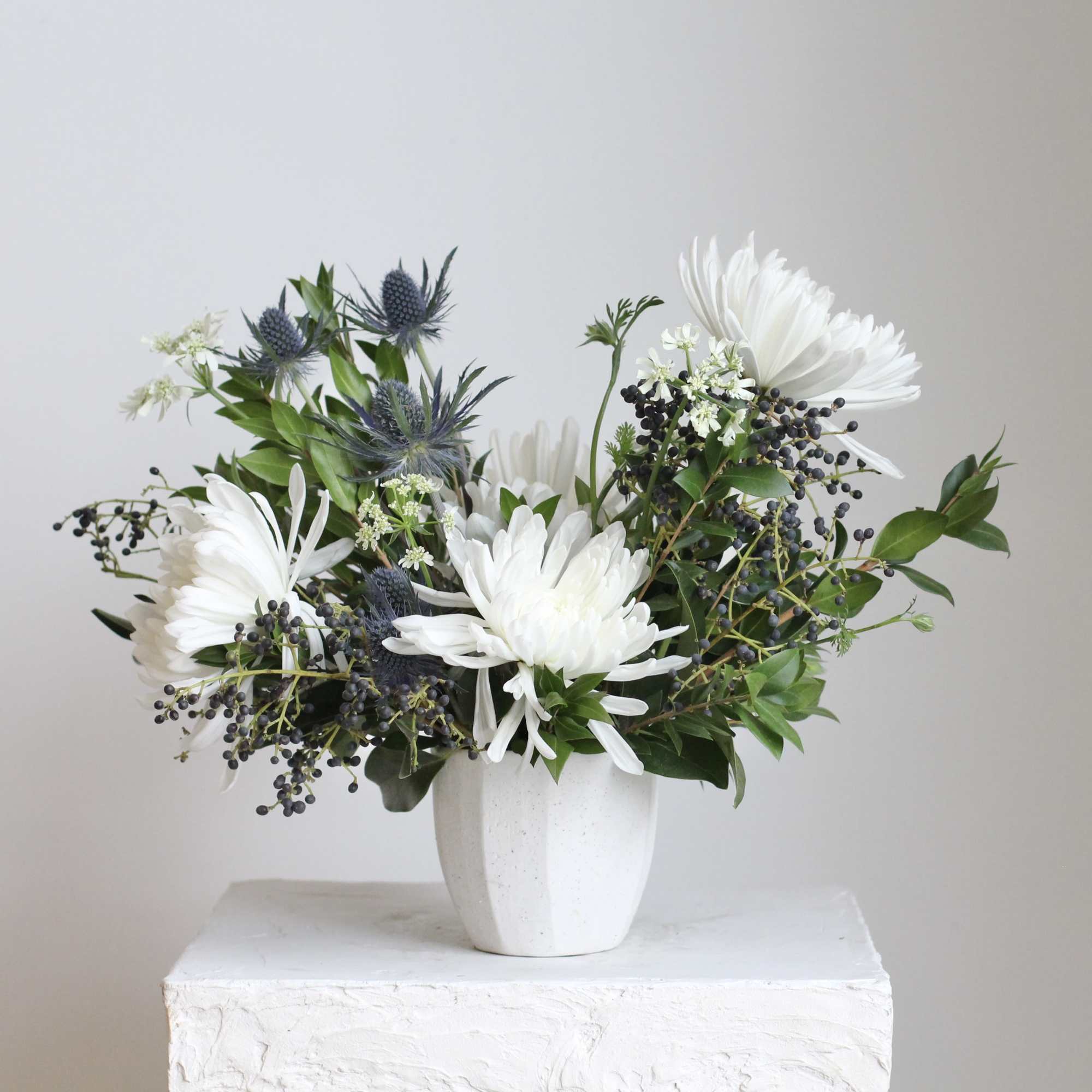 Delicate blue nigella and orlaya add soft, intricate textures, while fresh myrtle