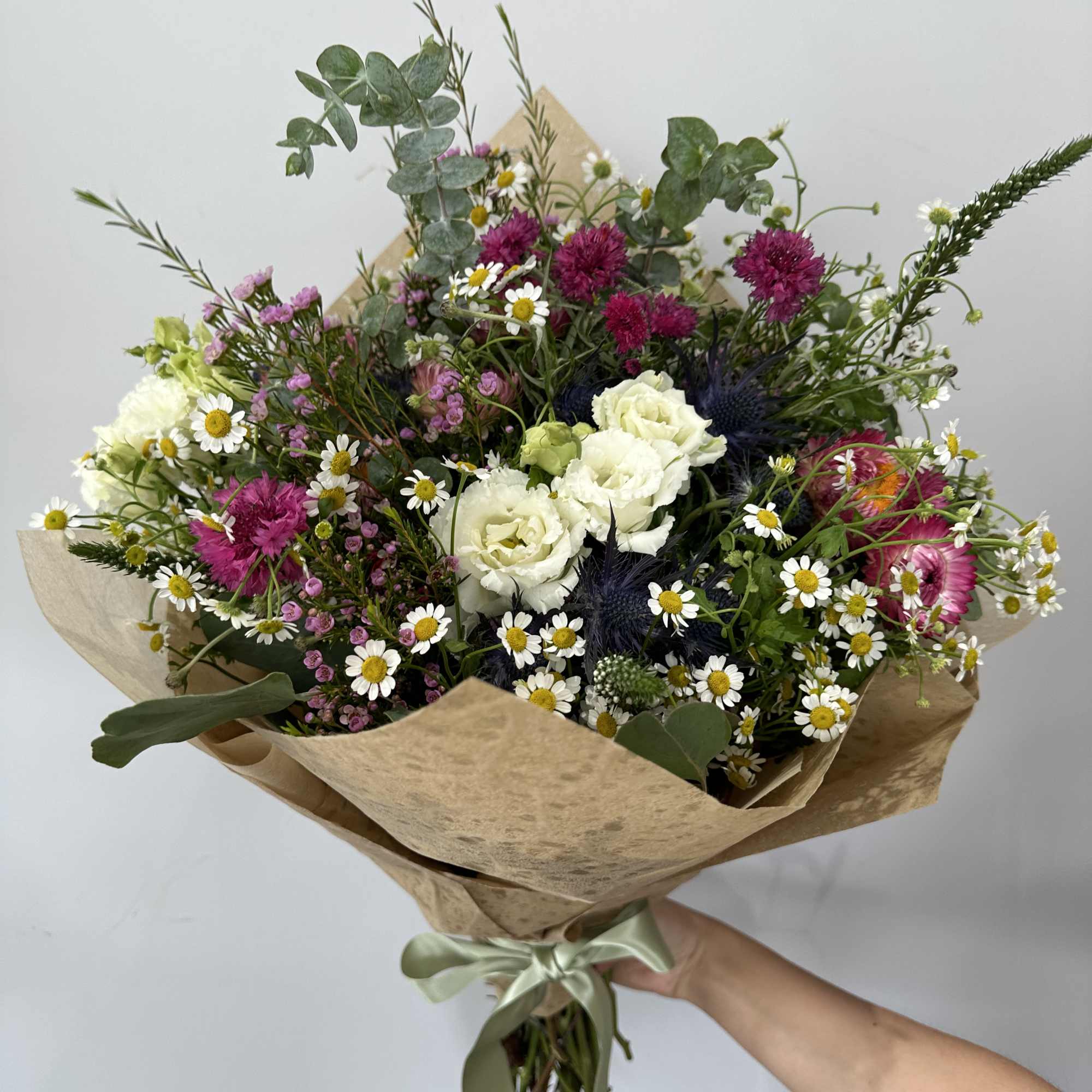 Seasonal wild flowers arranged in a bouquet (no vase). 

Please note, bouquet