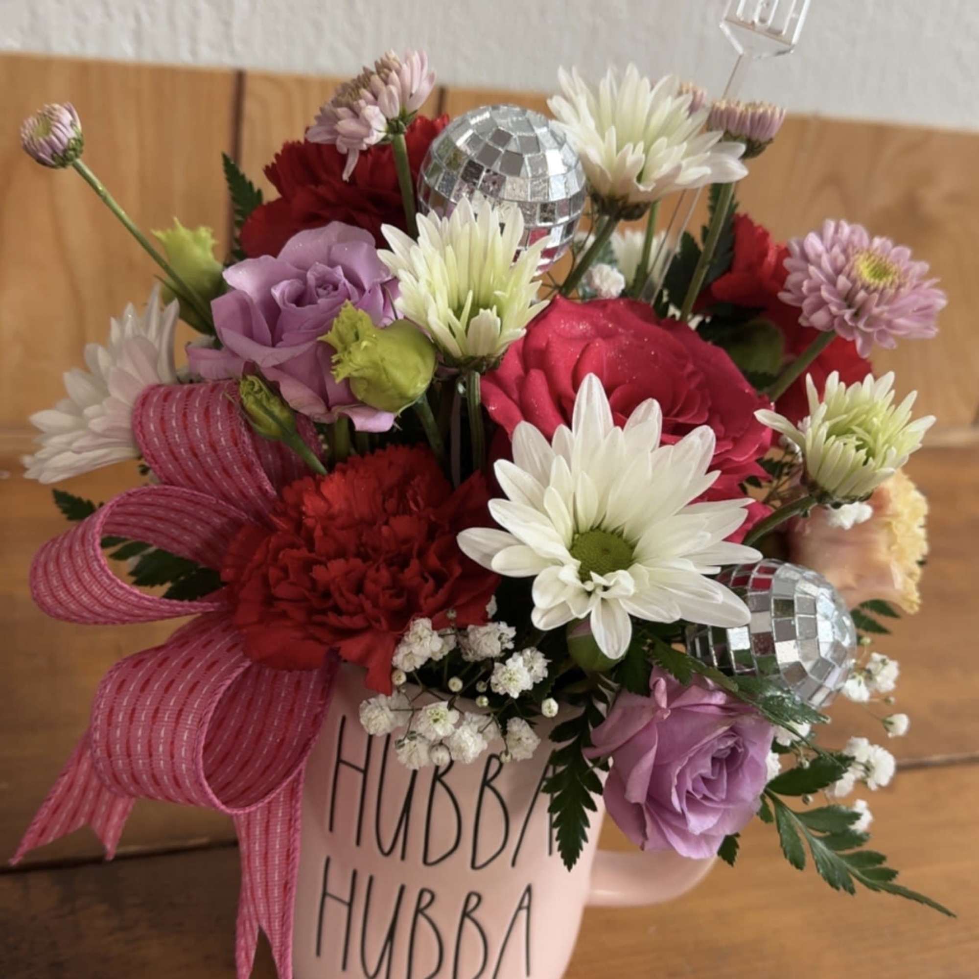 Valentine's day coffee mug filled with assorted florist choice of flowers. 