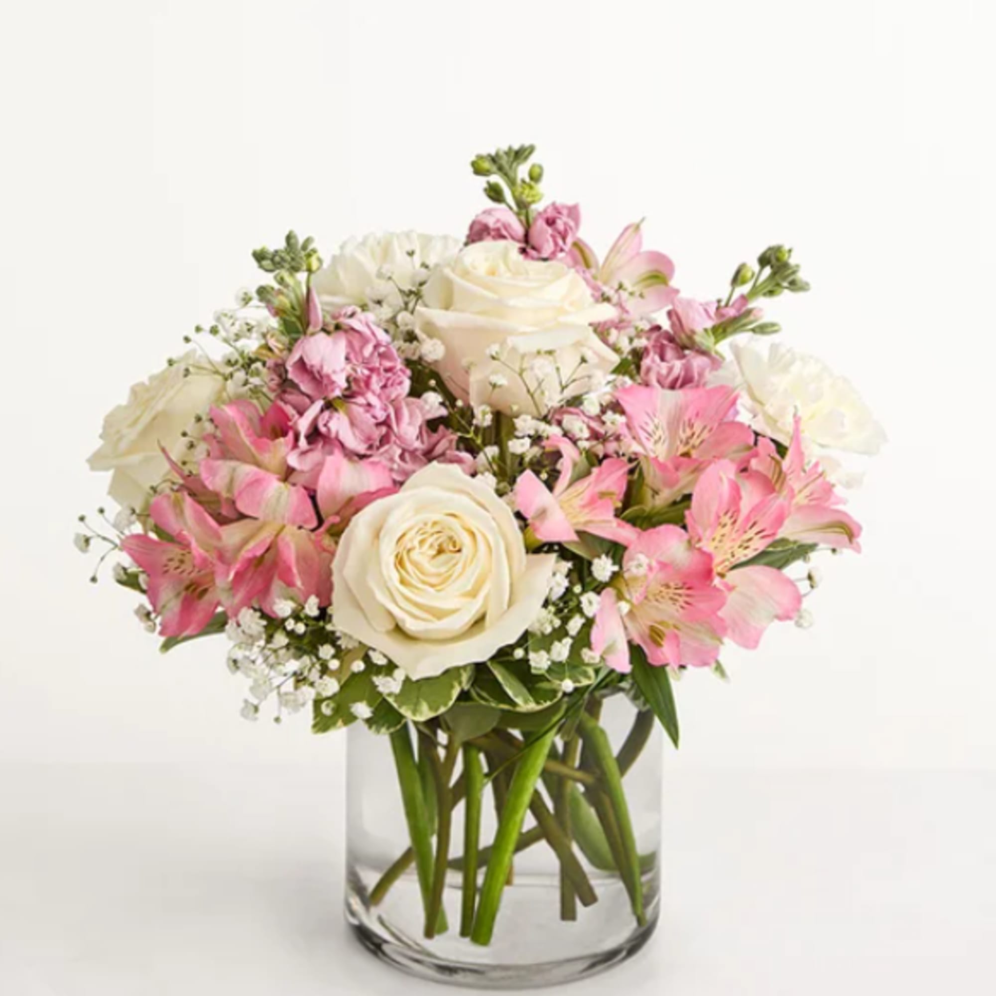 Our graceful arrangement in shades of blush pink and creamy white is