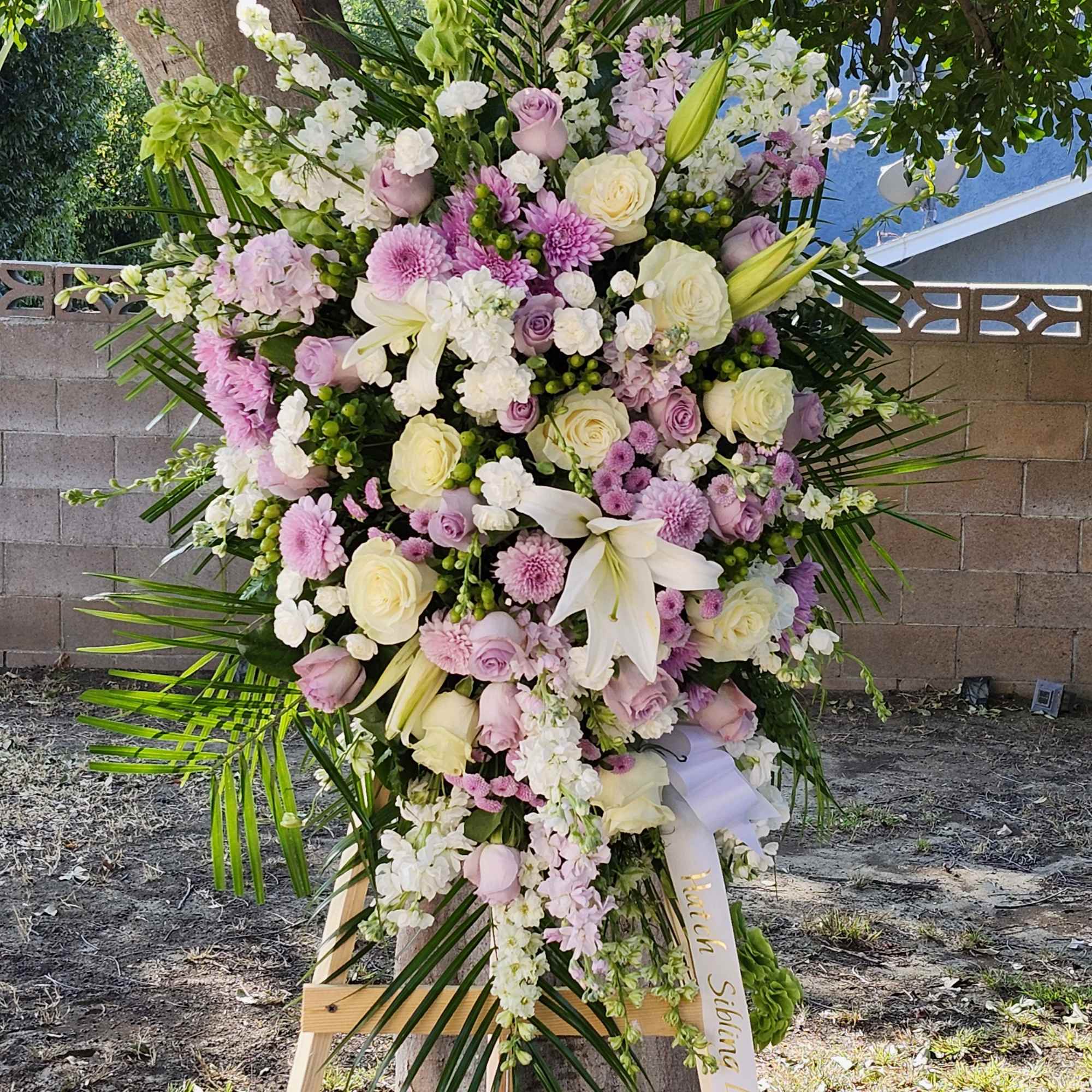 Lavender Funeral flower Spray arrangement filled with roses and many more beautiful