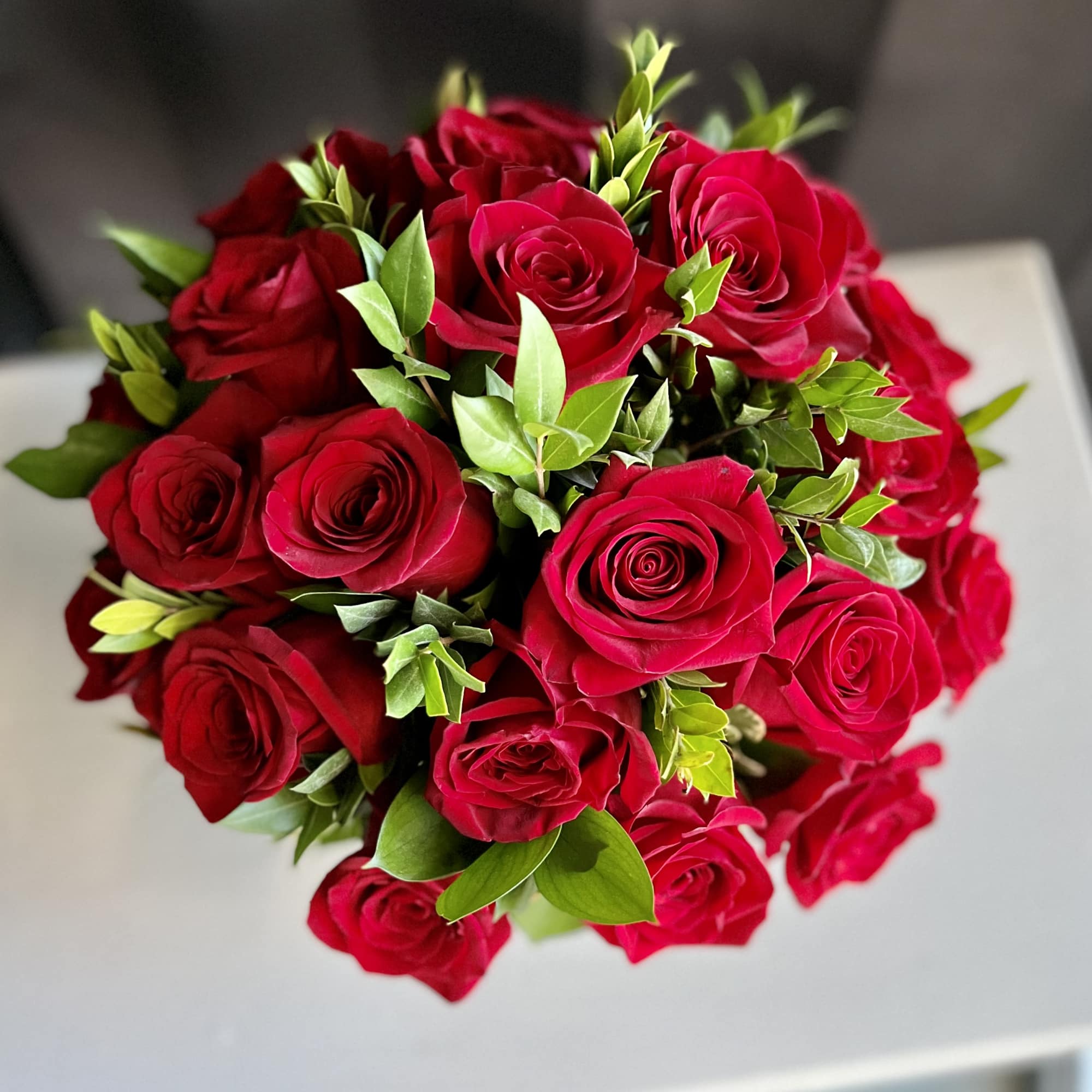12 premium red roses in a low and lush style
