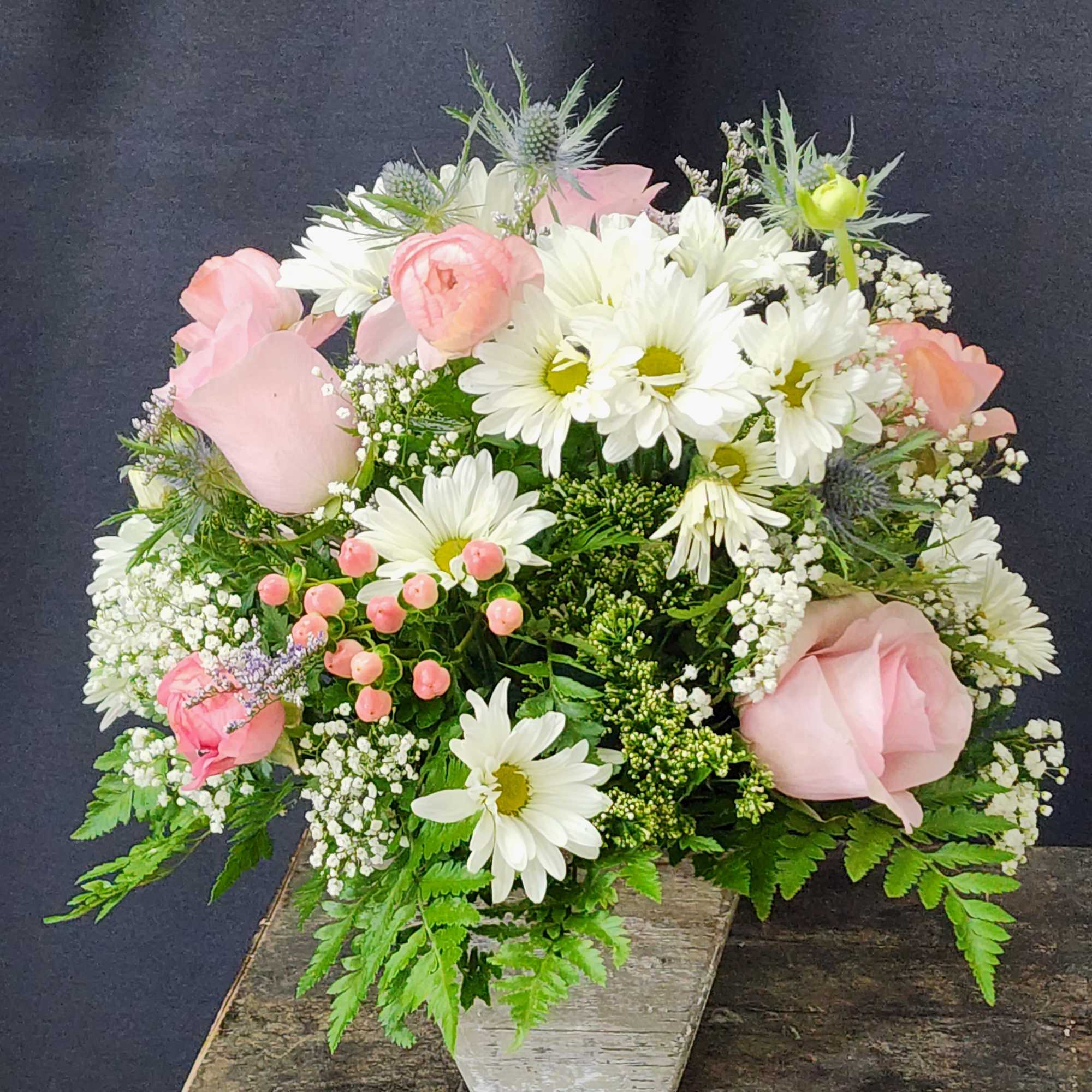 Soft and femine white and pink mix of seasonal flowers in a