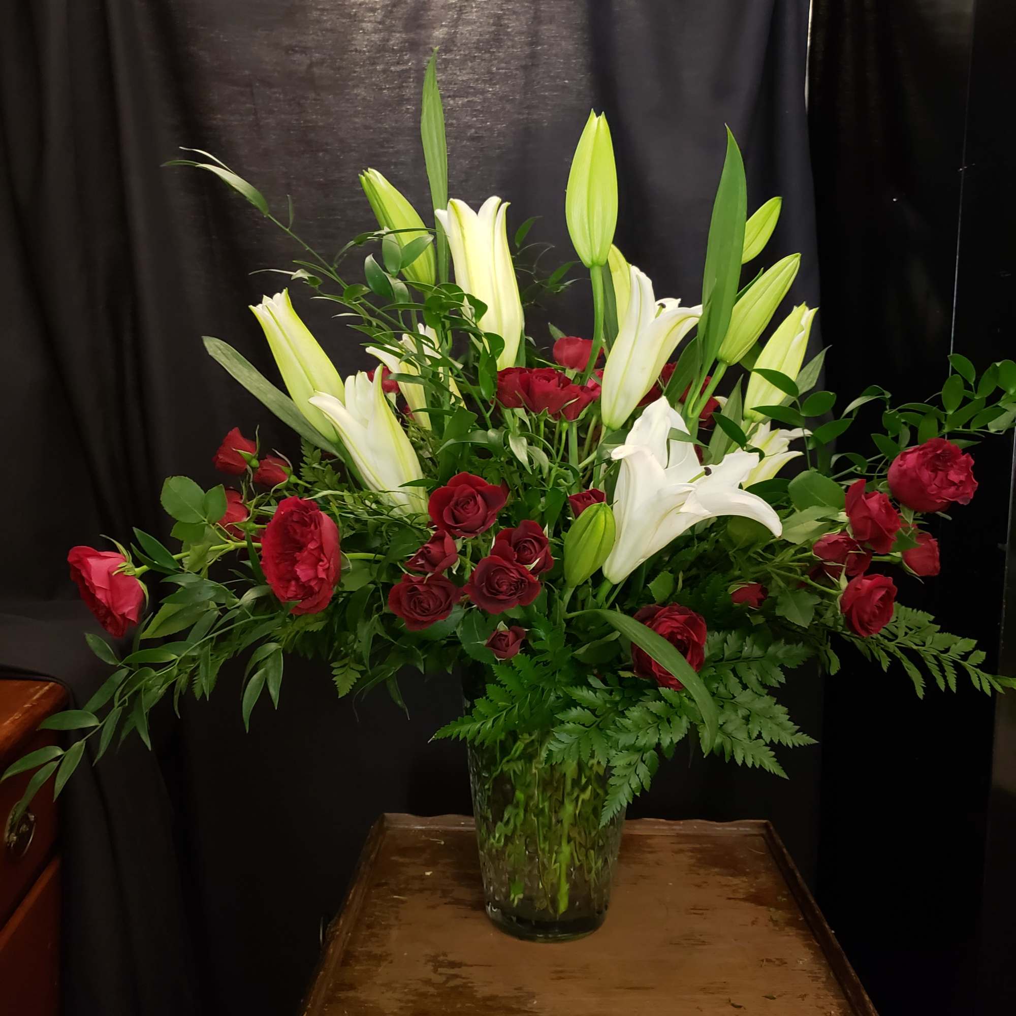 White lilies, Red Spray Roses and lush greenery, Pure Love is a