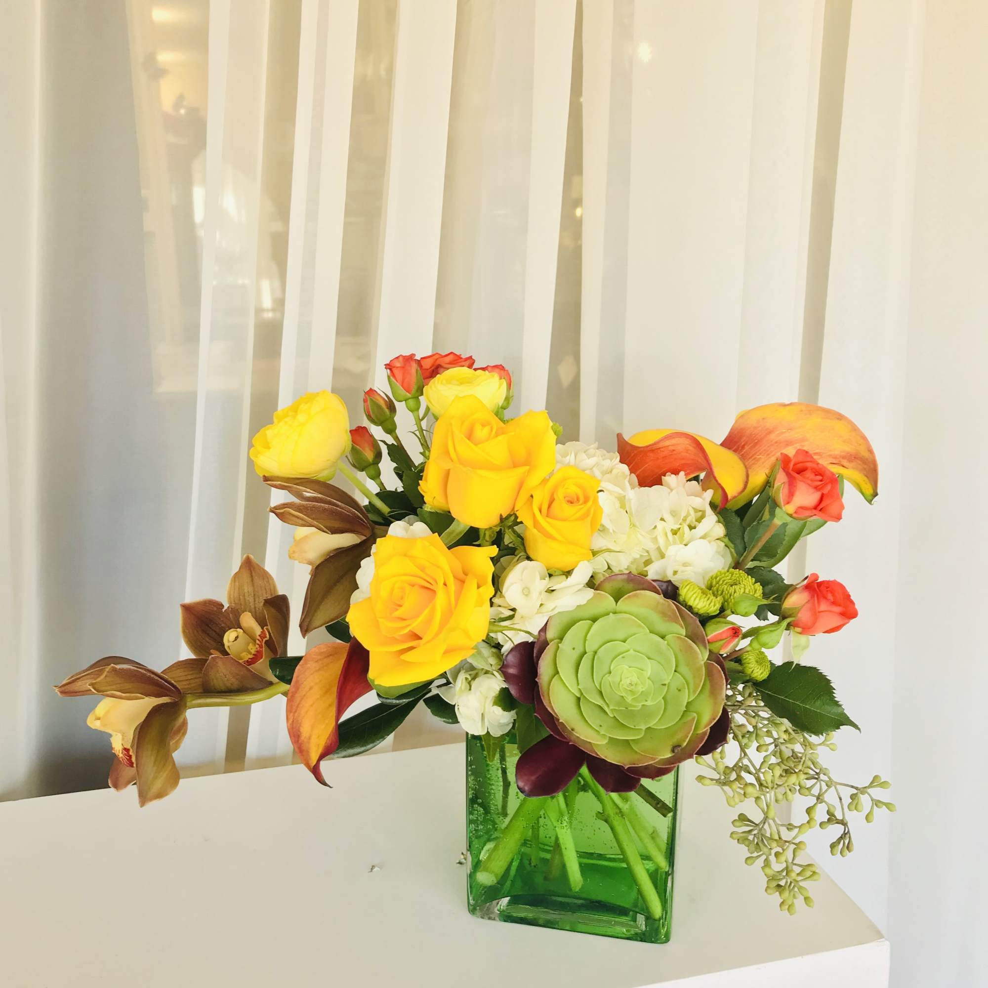 This vibrant colored arrangement is sure to bring happiness and luck to