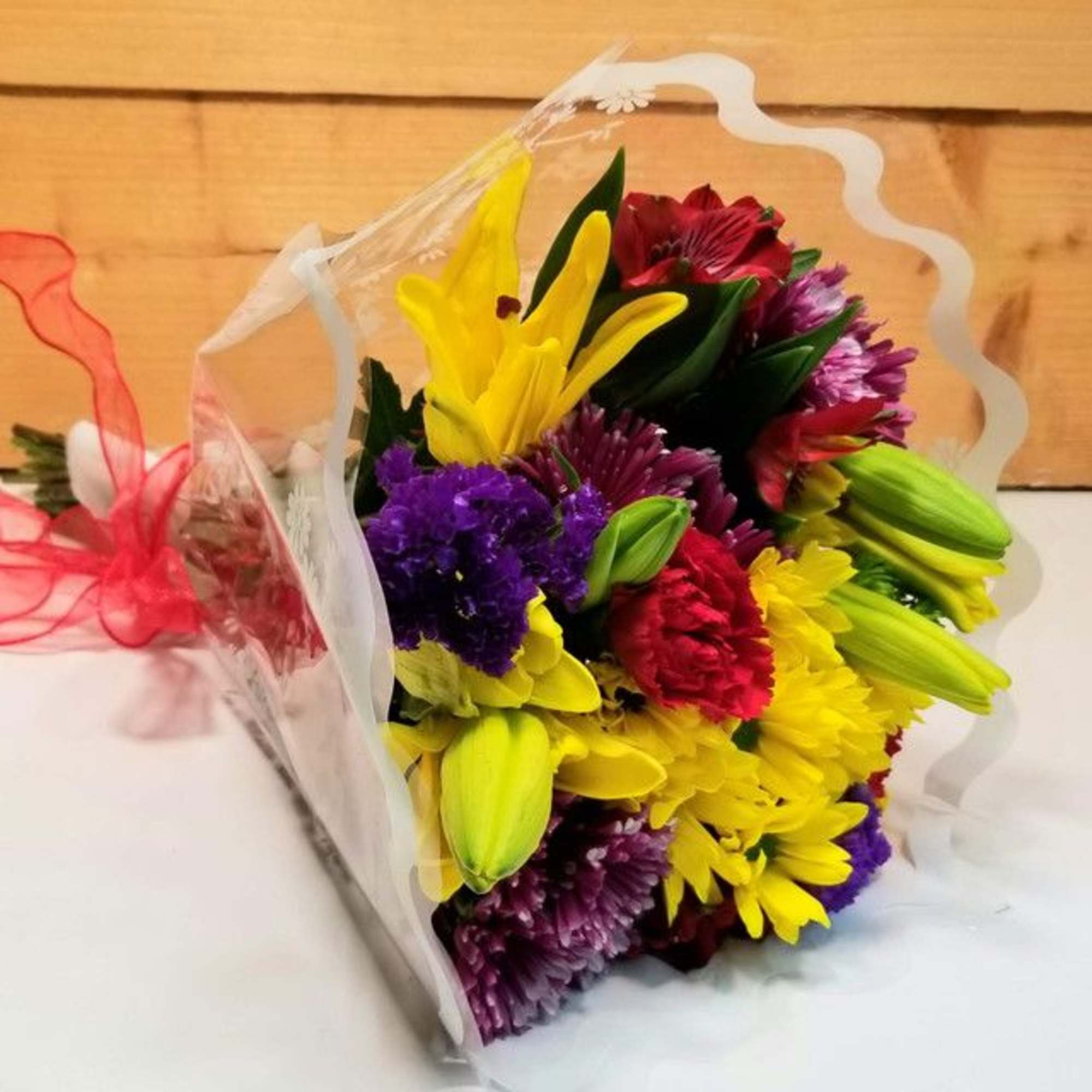 The Wrapped Brights Bouquet by Savilles Country Florist.  Wrapped bouquet of